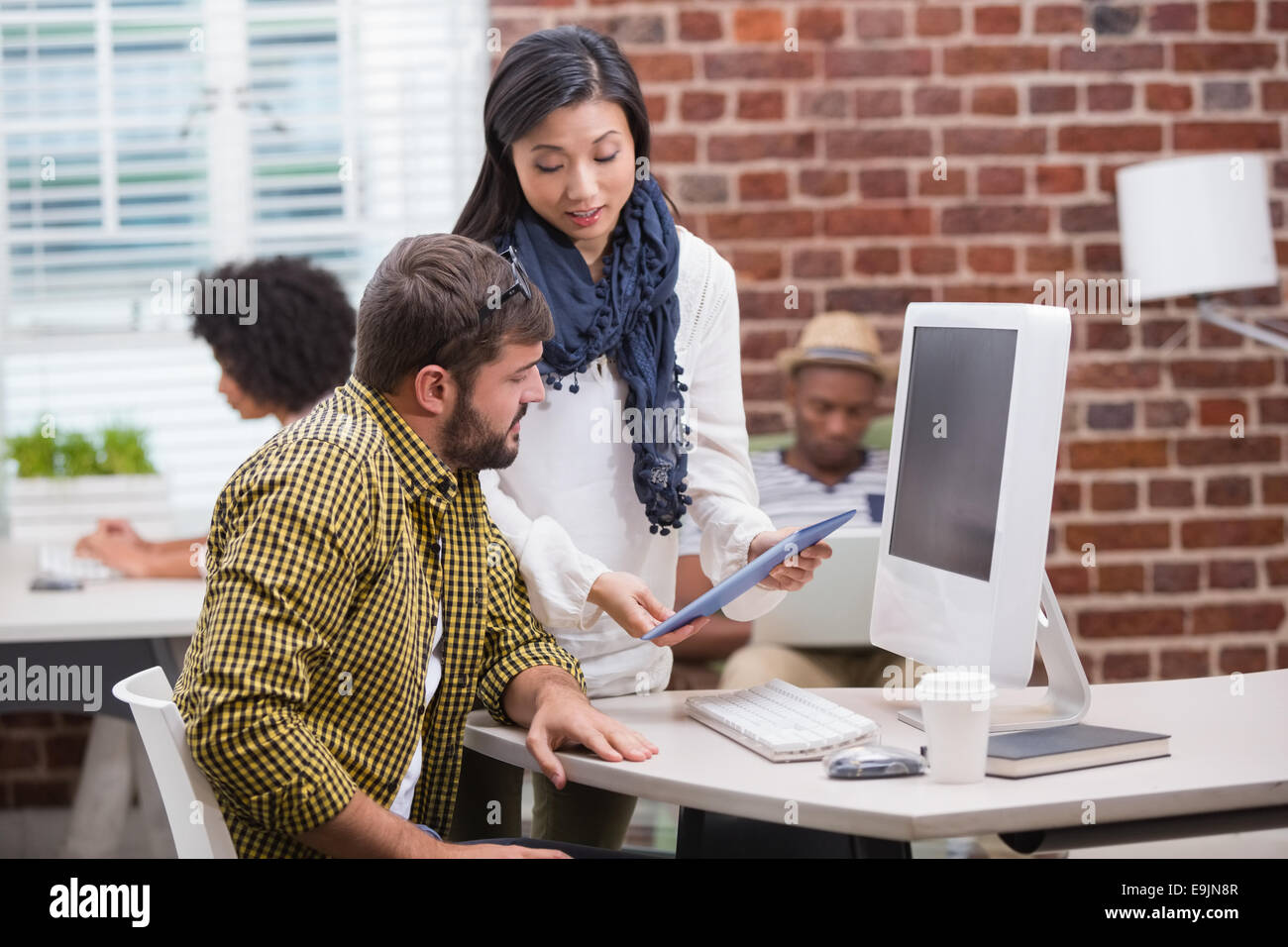 Creative people looking at digital tablet Banque D'Images