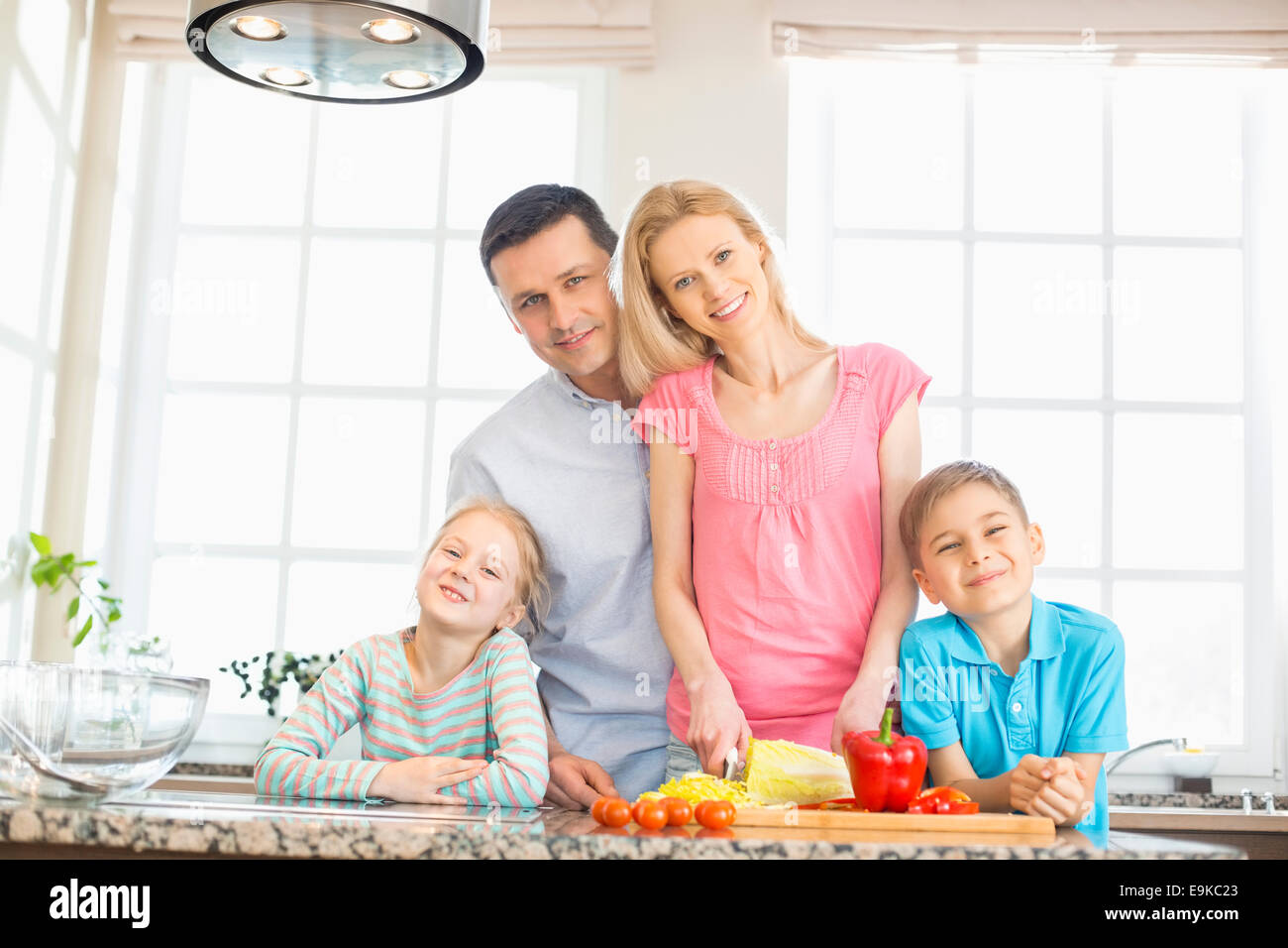 Portrait of happy family preparing food in kitchen Banque D'Images