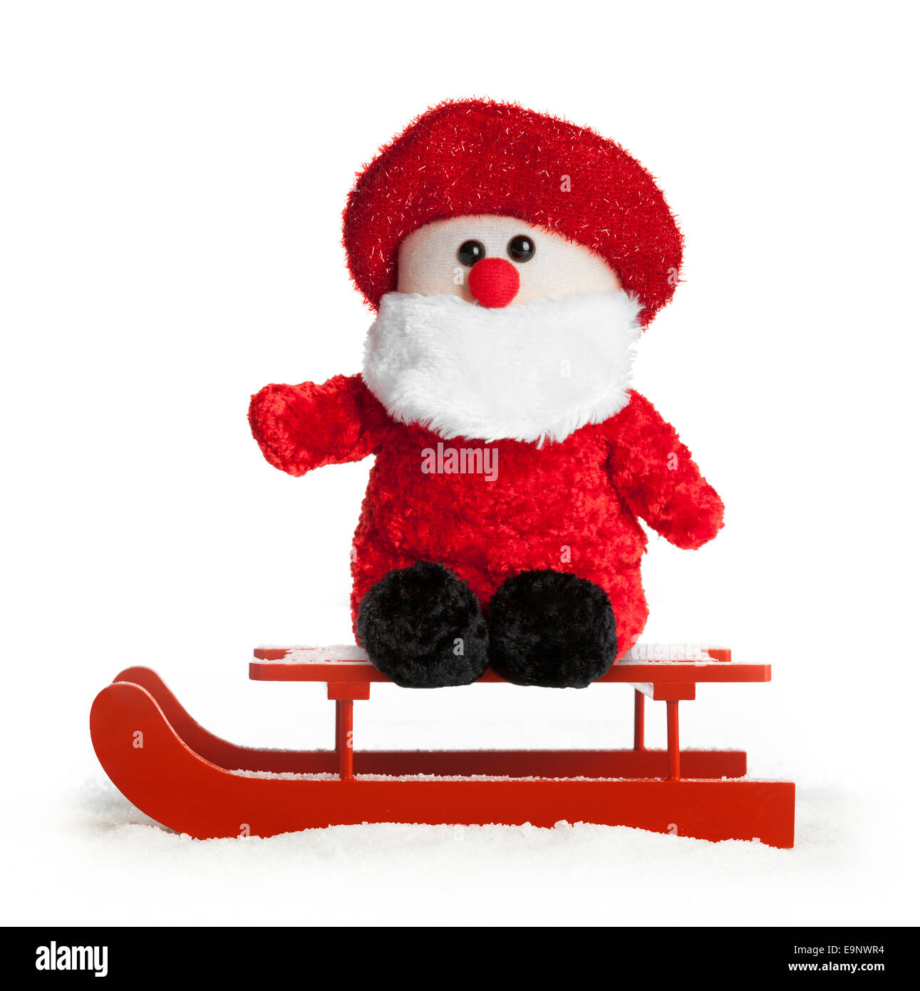 Rouge en bois traîneau avec le père noël sur fond blanc en peluche. Banque D'Images