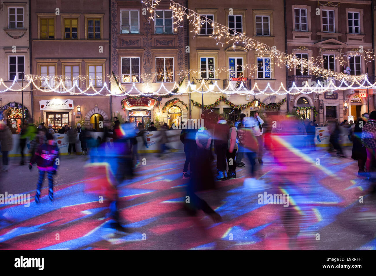 Les gens patiner sur glace pendant la période de Noël sur la place de la vieille ville de Varsovie, Pologne. Banque D'Images