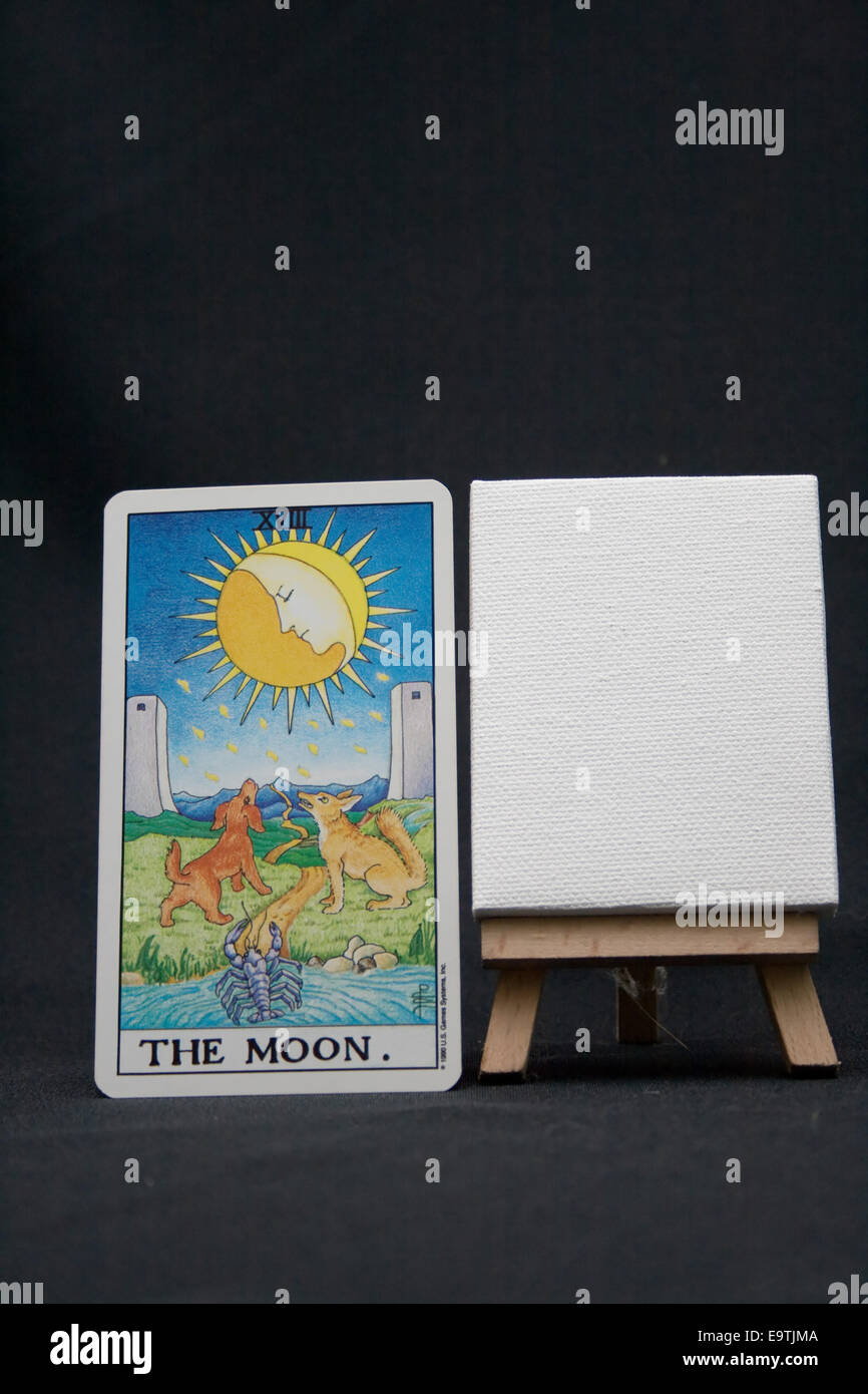 Carte de tarot la lune à côté d'une toile blanche sur un fond sombre Photo  Stock - Alamy