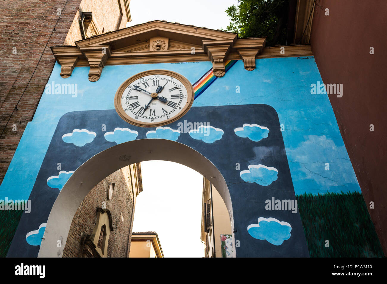 Œuvres d'équilibre peint sur le mur des maisons du petit village médiéval de Dozza près de Bologne en Émilie-Romagne, Italie. Vieille horloge au milieu. Banque D'Images