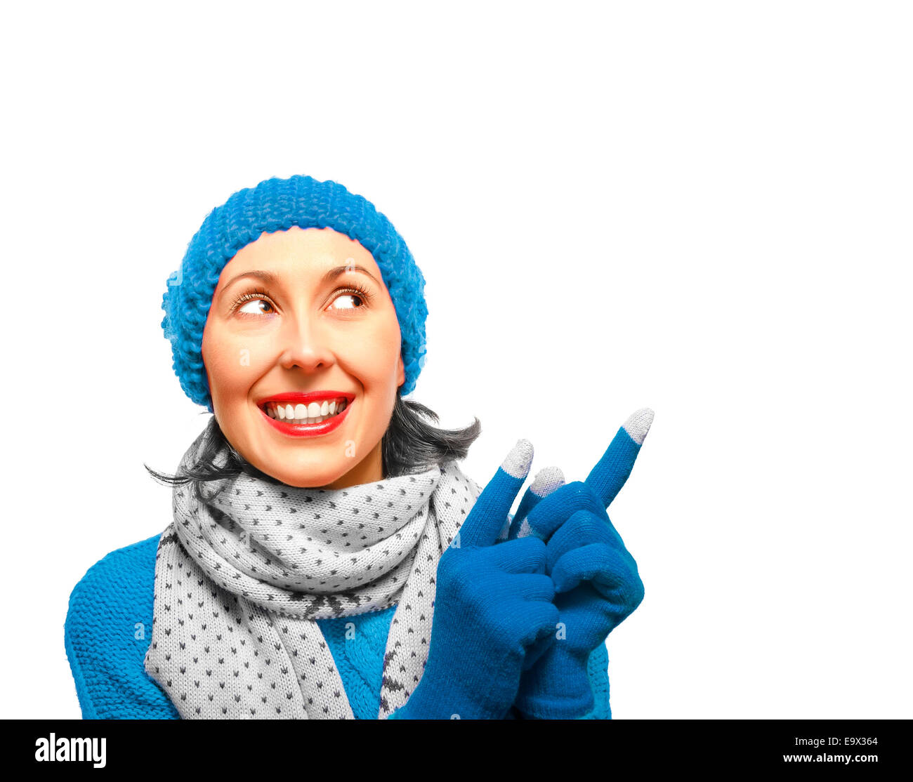 Girl in winter clothes smiling et montrant le haut Banque D'Images