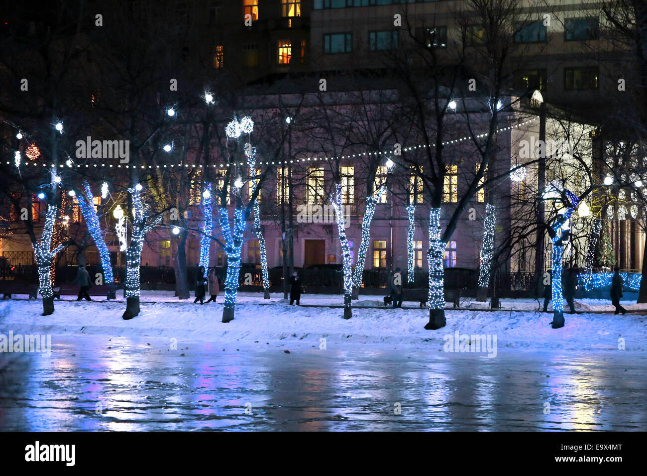 Les lumières dans le parc d'hiver sur les arbres et bâtiments à Moscou Banque D'Images