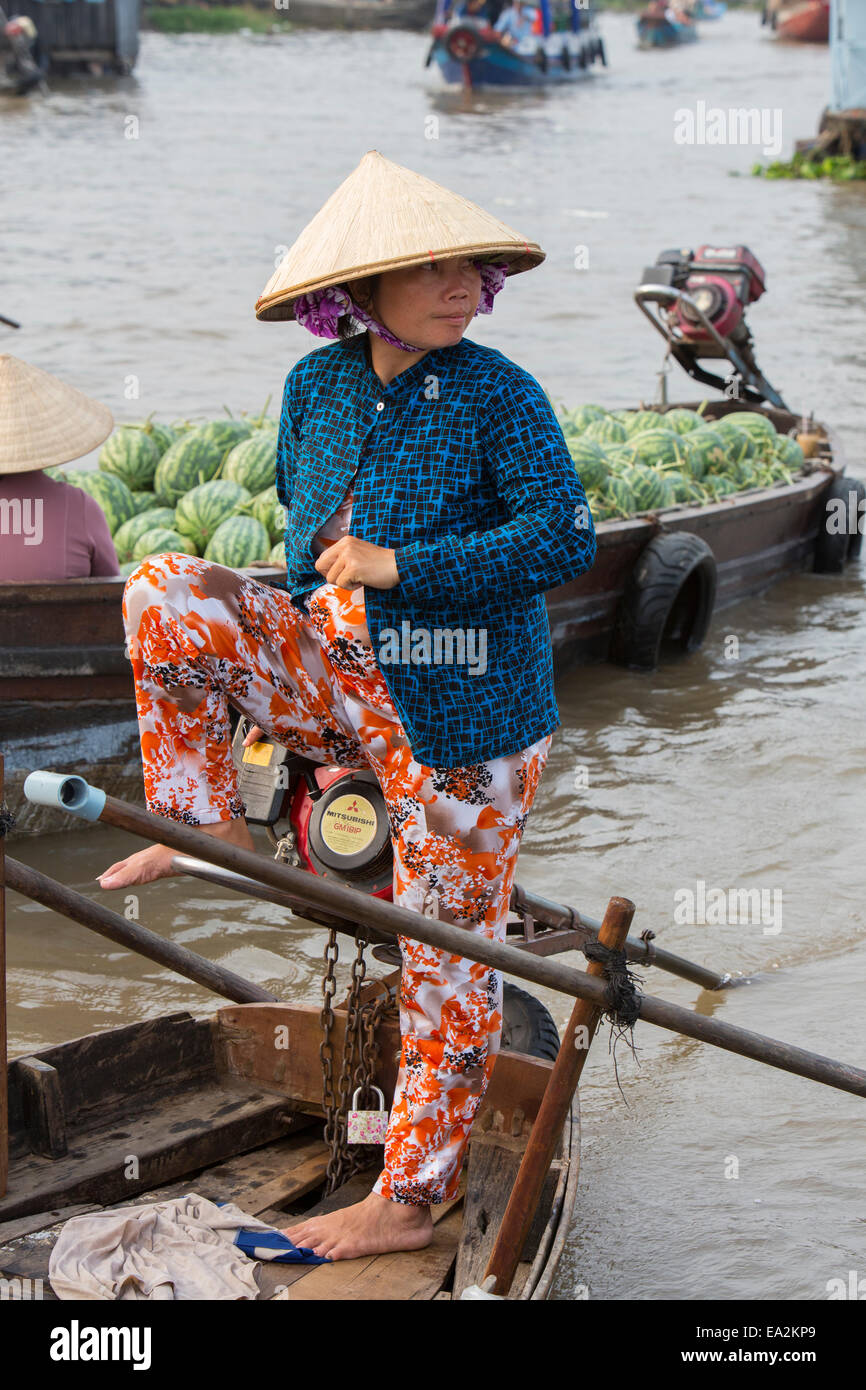 Femme au volant bateau en bois au Mékong, marché flottant, Vietnam Banque D'Images