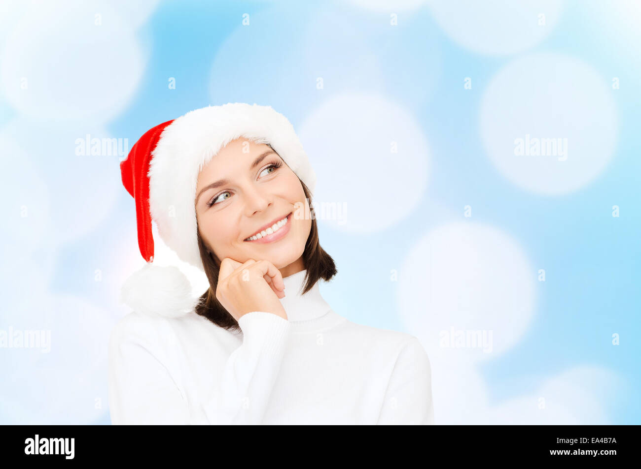 Penser et smiling woman in santa helper hat Banque D'Images