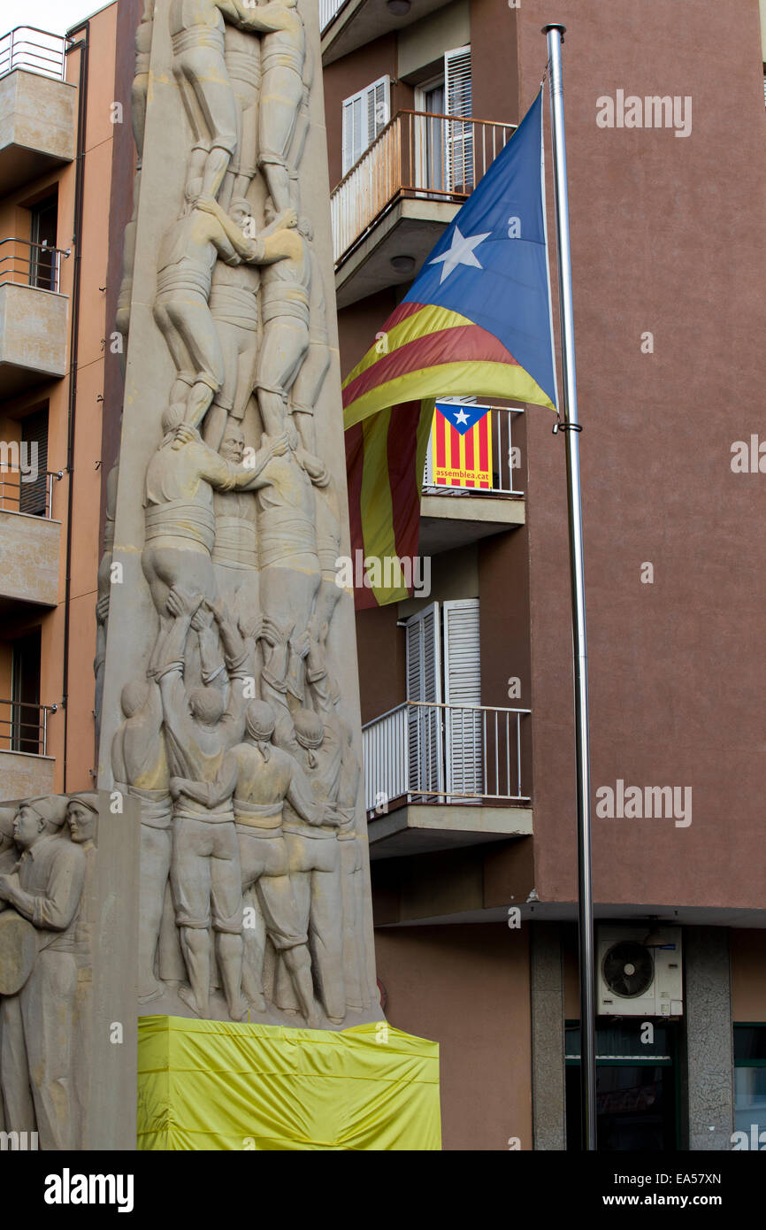 Valls, Catalogne, Espagne. Un fragment d'un monument de la tour entourée d'un tissu jaune et un drapeau de la Catalogne. Banque D'Images