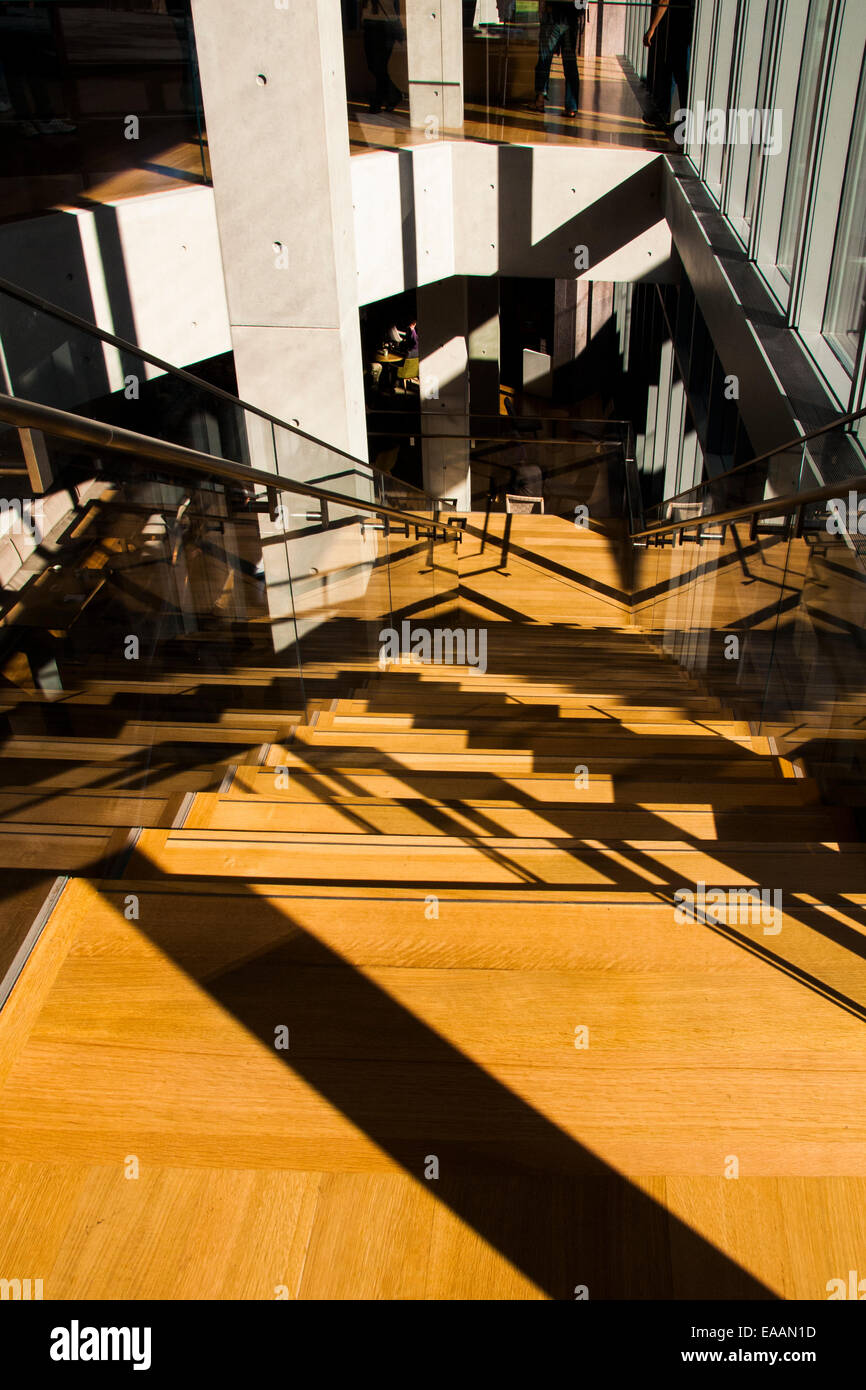 Exemple de l'architecture moderne dans un bâtiment public murs de verre béton métal escalier parquet en chêne et de la lumière du soleil et d'ombre Banque D'Images