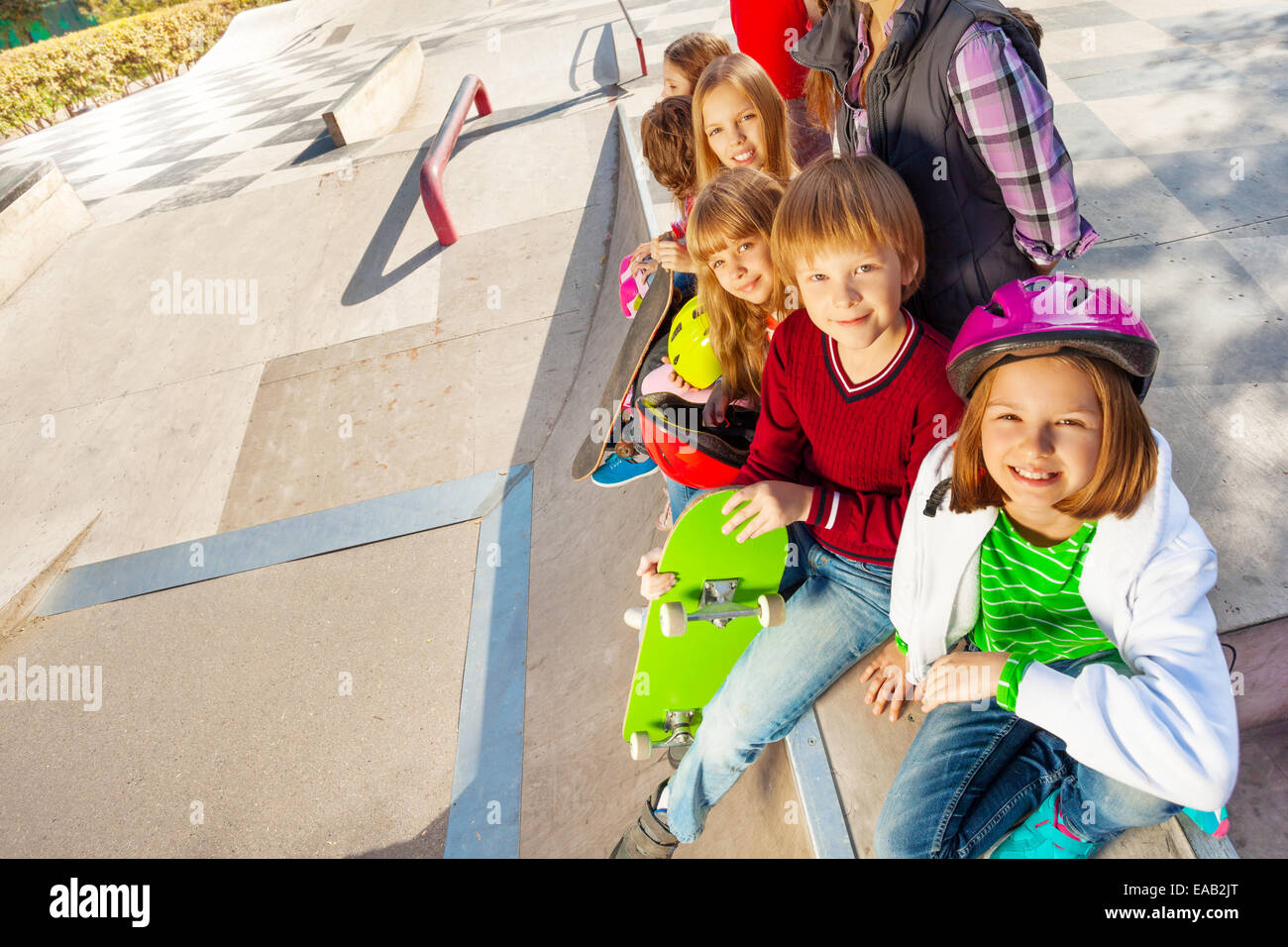 Smiling kids avec skateboards et casques Banque D'Images