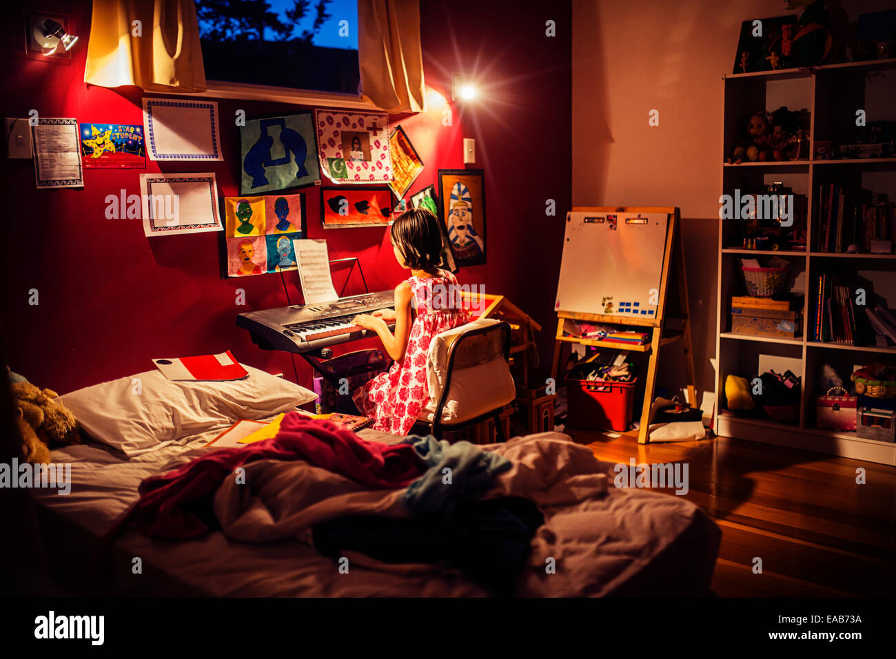 Pratiques fille piano dans sa chambre. Texte identifiable déposé. Banque D'Images