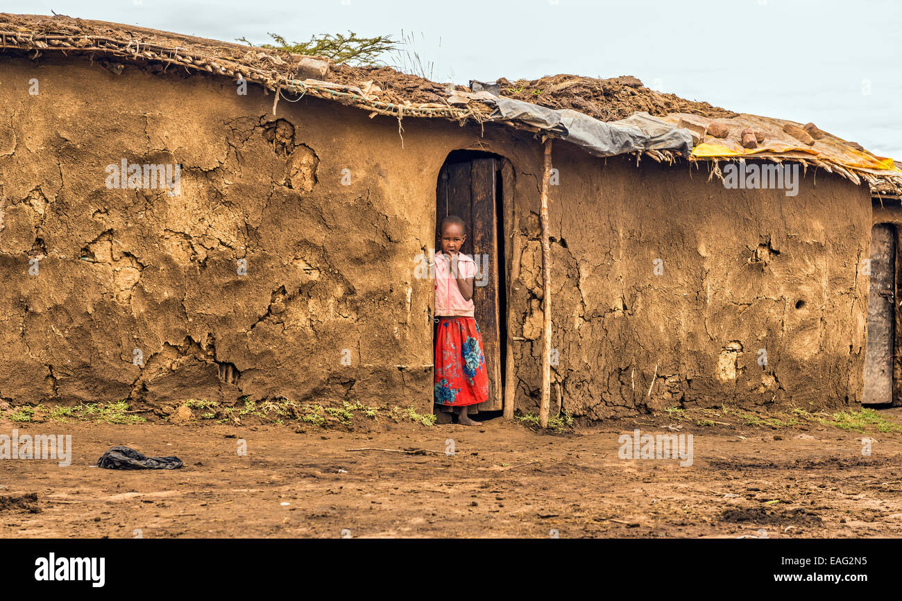 Jeune fille africaine de la tribu masai dans la porte de sa maison Banque D'Images