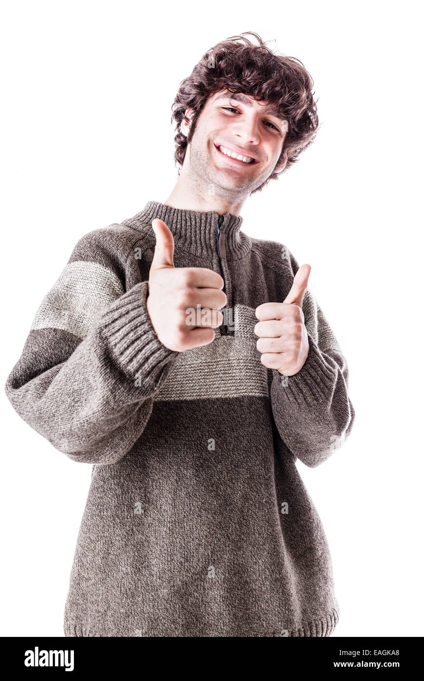 Un beau gars, peut-être un étudiant, dans des vêtements décontractés avec Thumbs up. isolated over white Banque D'Images