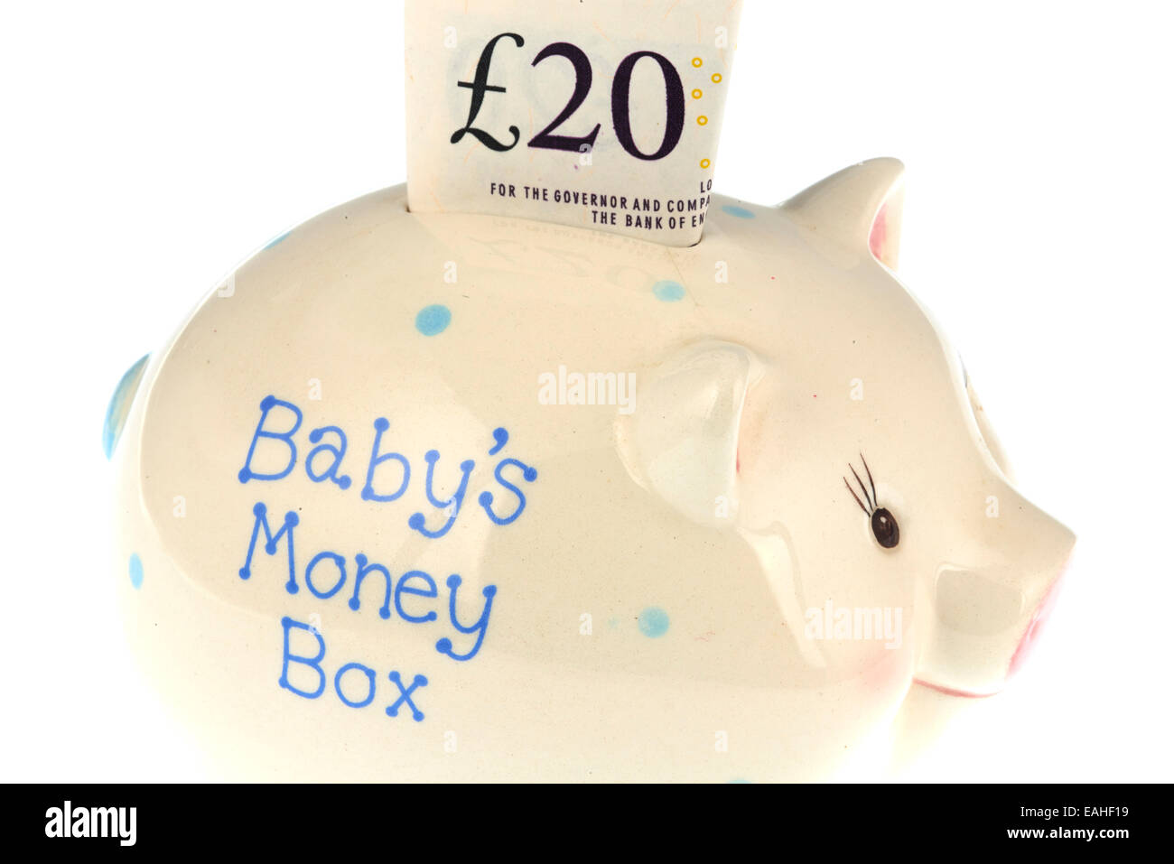 Tirelire du bébé avec une note de 20 livres Banque D'Images