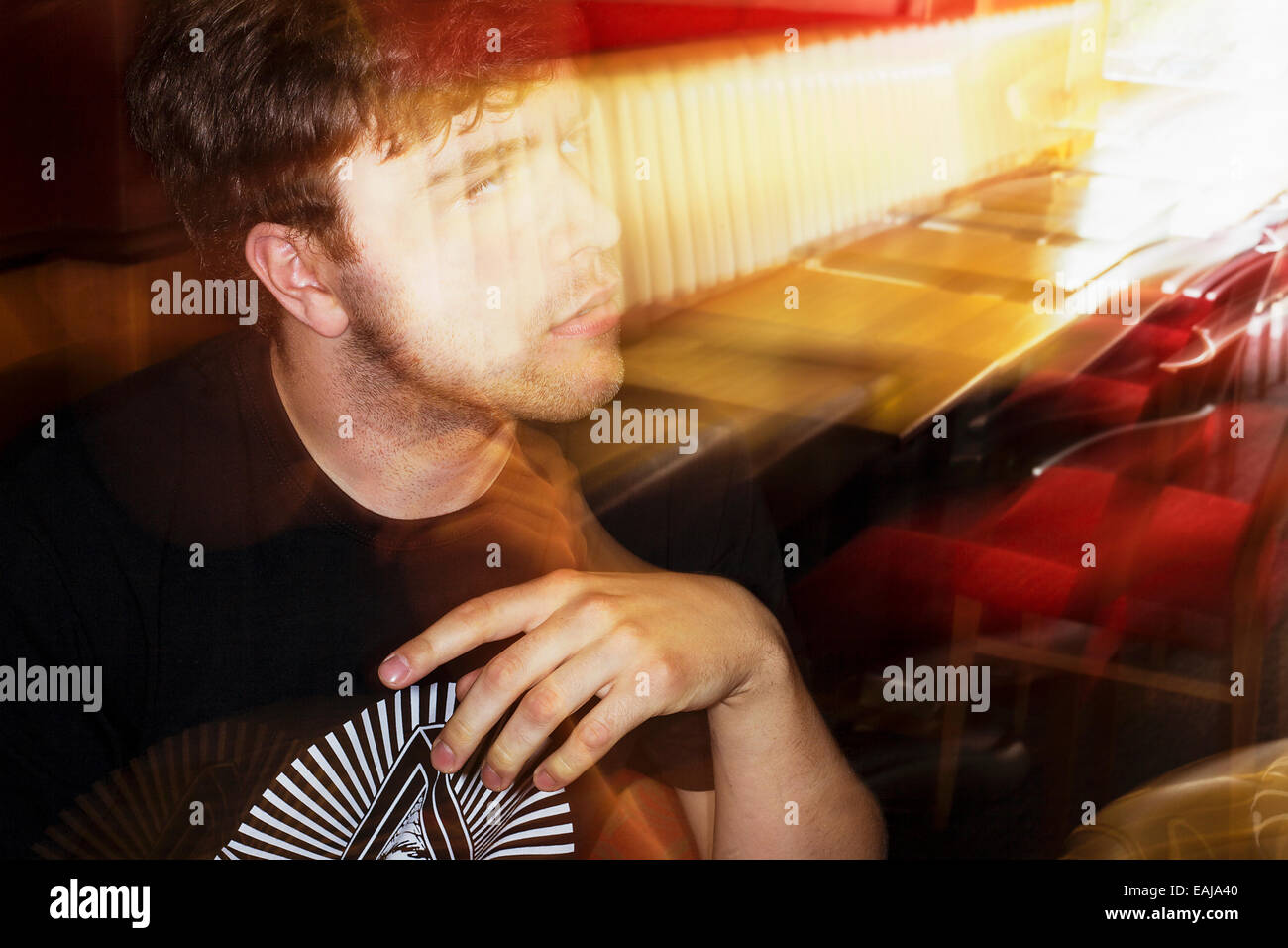 Un homme blanc de 19 ans dans un café tourné au Royaume-Uni, l'image est en couleur avec flash blur Banque D'Images