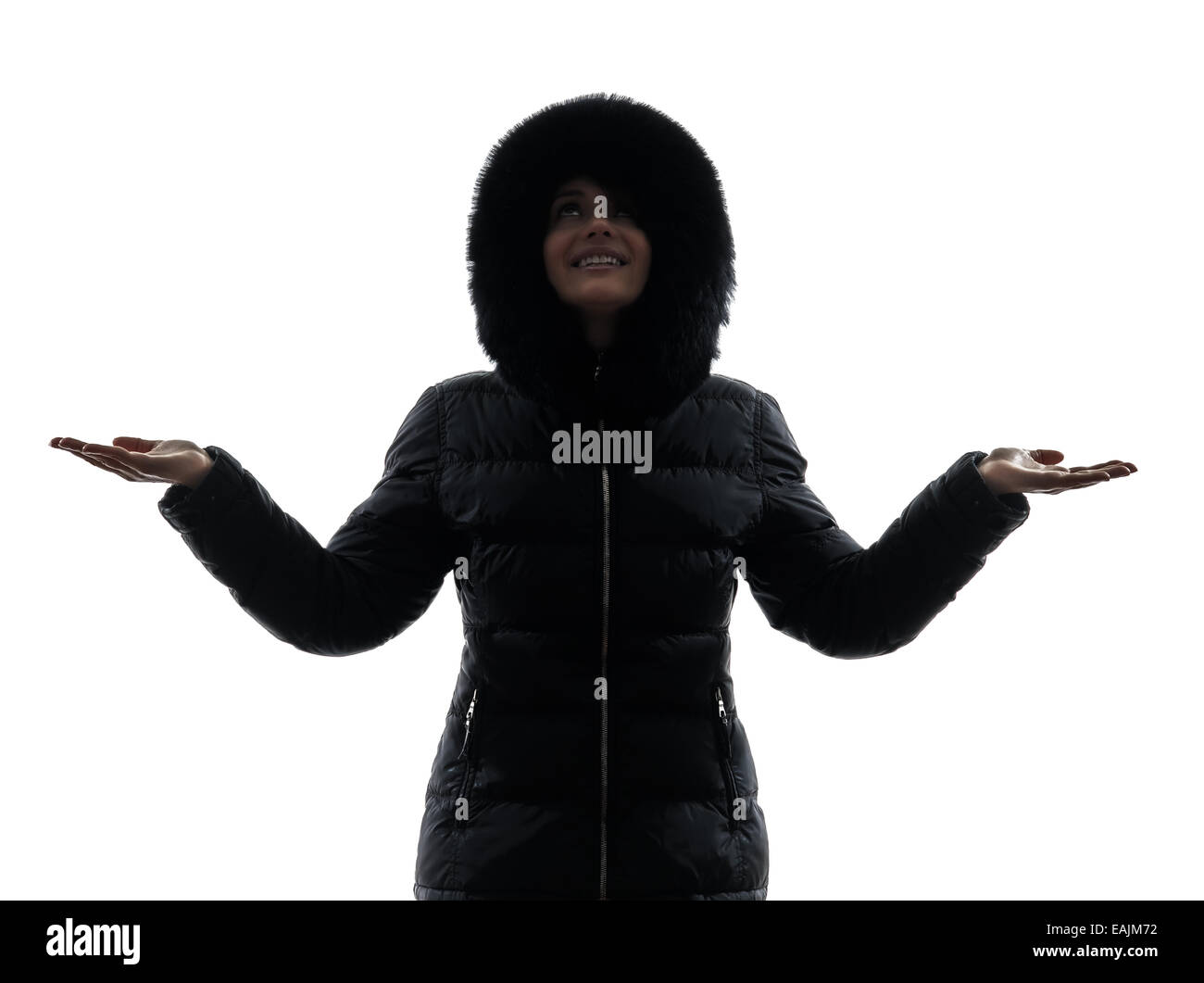 Une femme en manteau d'hiver les bras tendus heureux silhouette sur fond blanc Banque D'Images