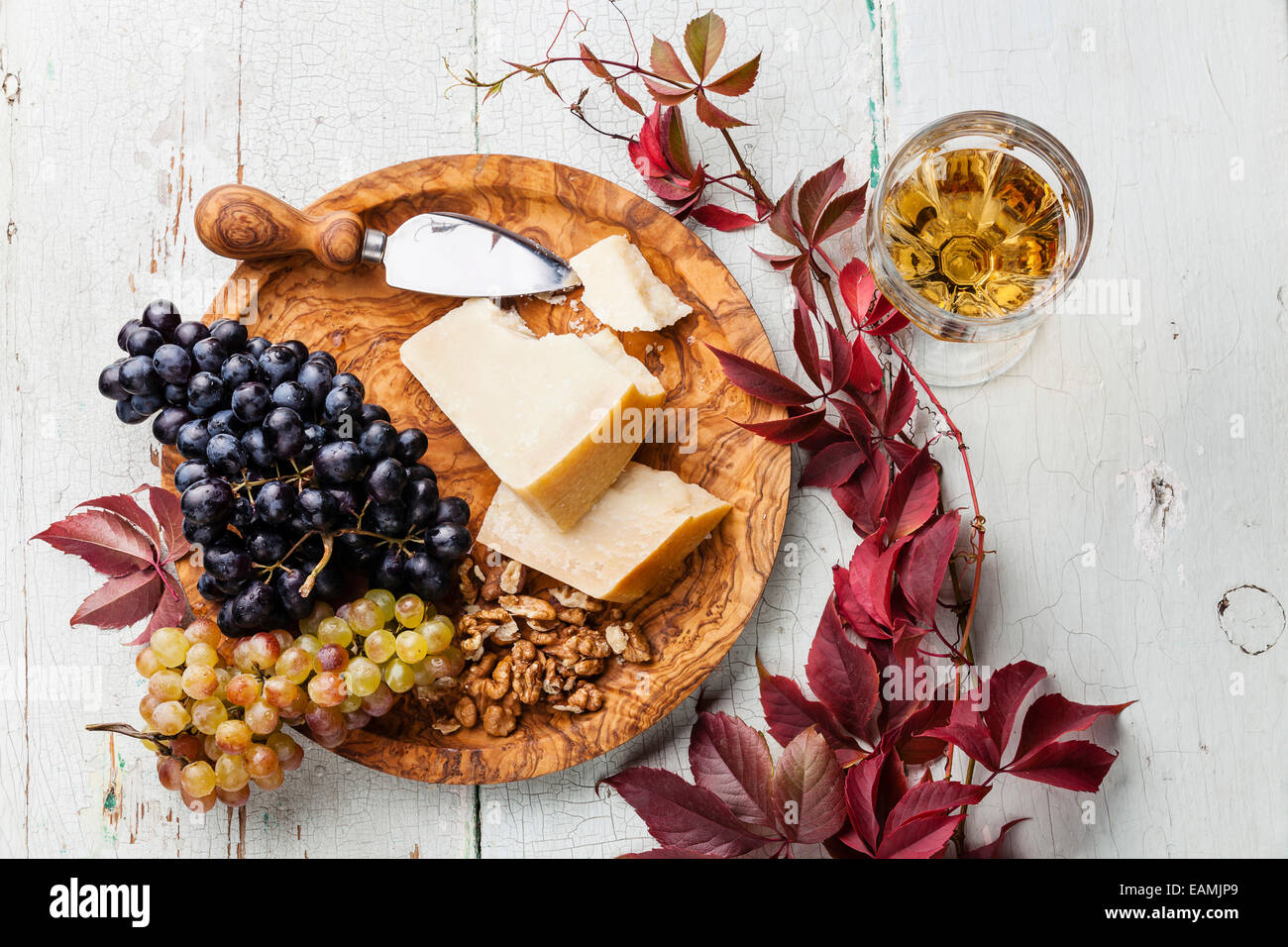 Fromage Parmesan et raisins sur plaque de bois d'olive et du vin Banque D'Images