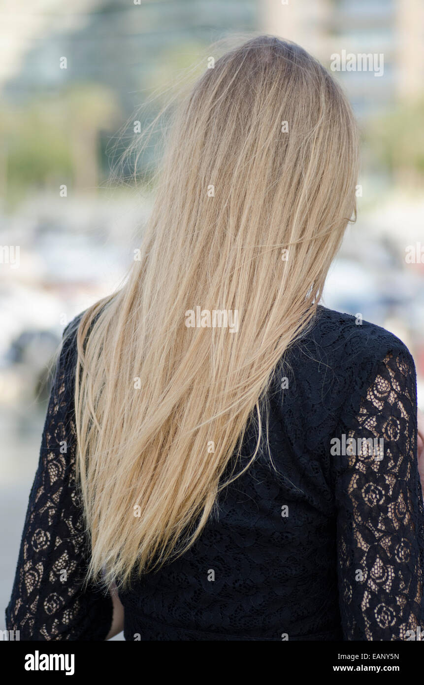 Vue arrière d'une jeune blonde woman standing outdoors Banque D'Images