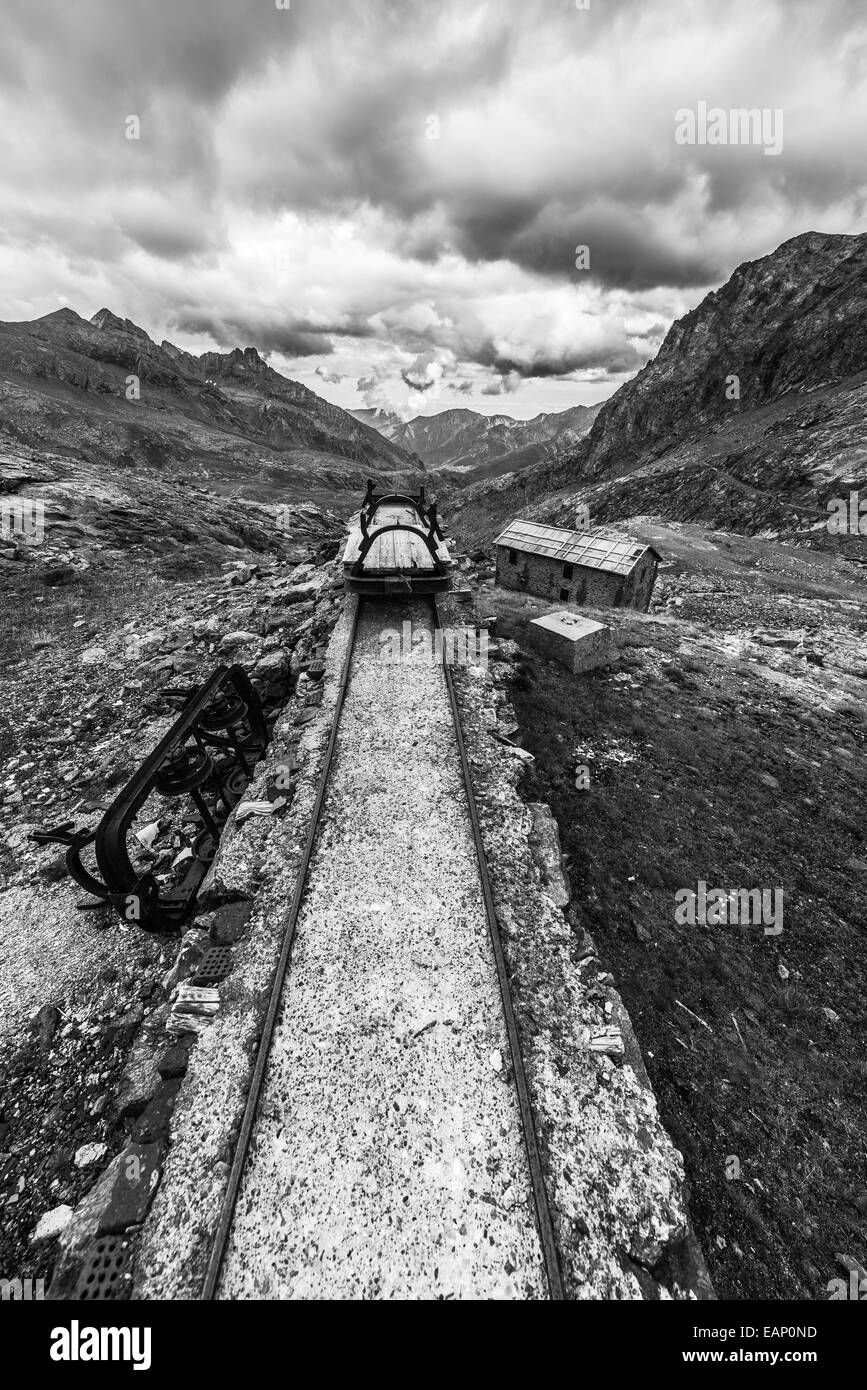 Ancienne voie ferrée endommagée et utilisés dans les Alpes italiennes pour la construction du barrage de haute altitude, transport de matériel ou d'exploitation minière pu Banque D'Images