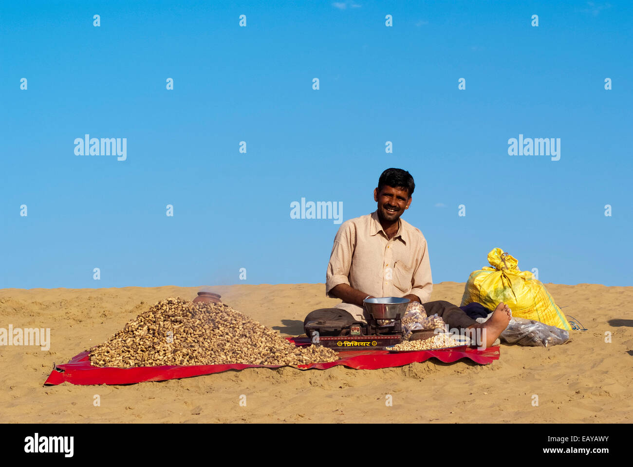 Un homme vend des cacahuètes cuites à la Sam dune de sable, Jaisalmer, Inde Banque D'Images