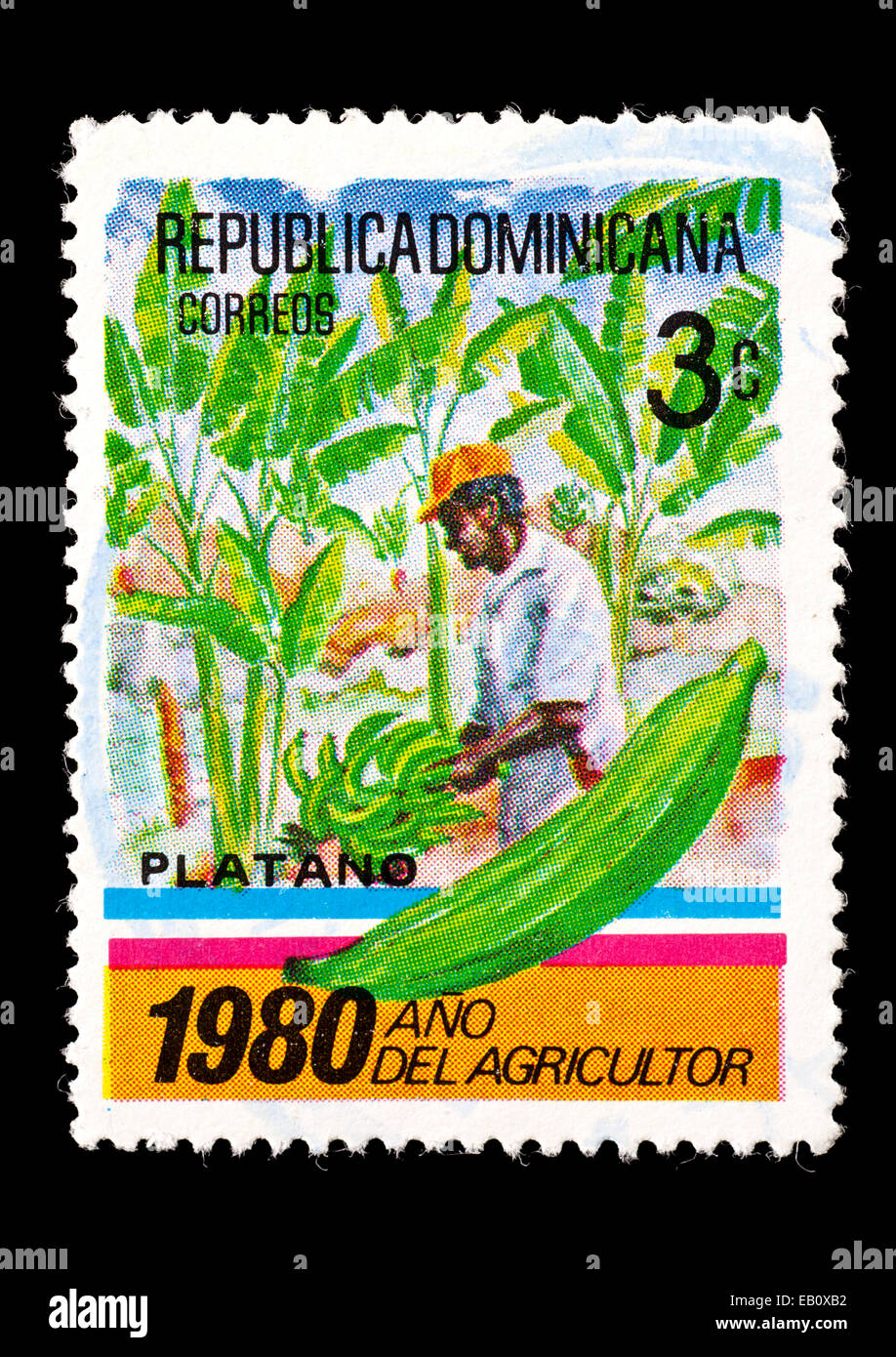 Timbre-poste de Dominique représentant un agriculteur vérifier ses cultures de plantain. Banque D'Images