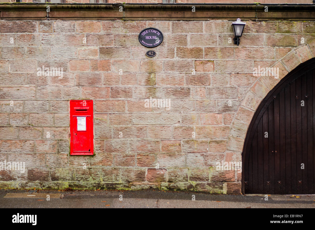 Boite aux lettres rouge dans le mur, Mur de grès, village Banque D'Images
