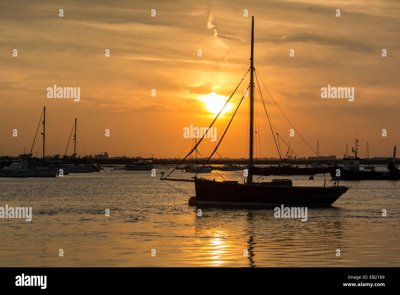 Coucher de soleil sur la rivière Deben avec bateaux à voile amarré à Bawdsey Suffolk Ferry Banque D'Images
