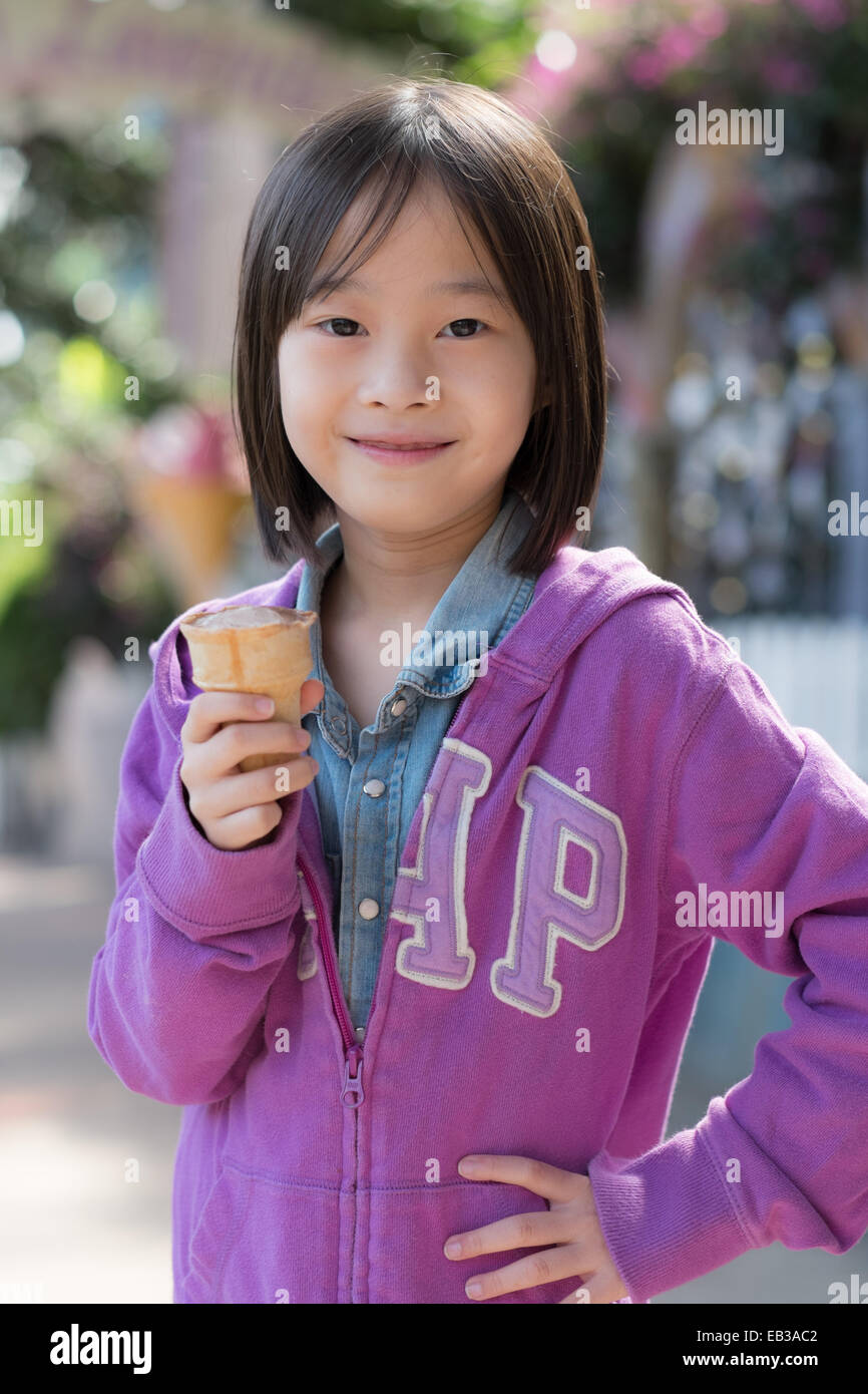 La Malaisie, Brinchang, Girl (8-9) eating ice cream Banque D'Images