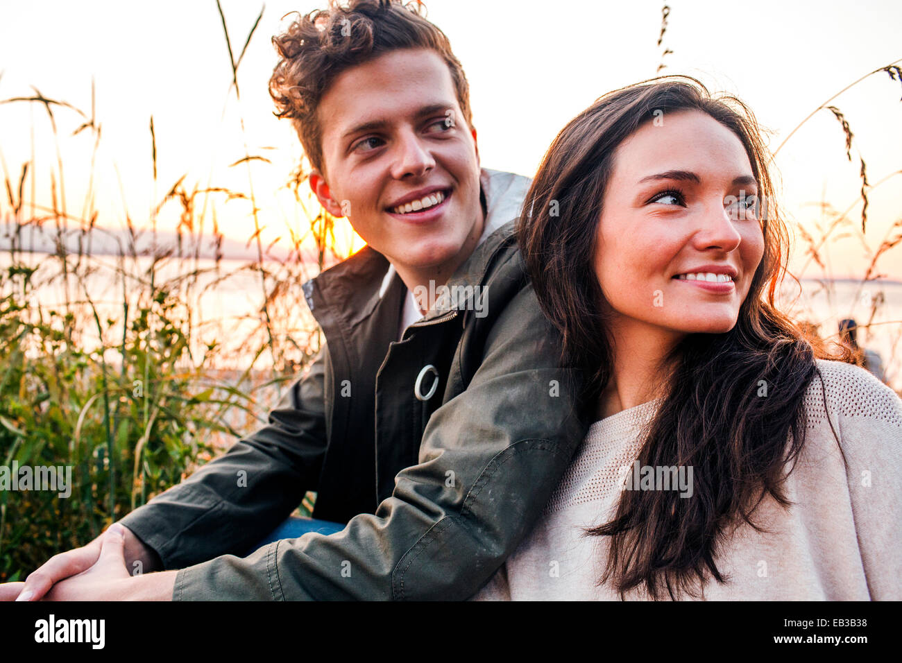 Young couple sitting on beach Banque D'Images