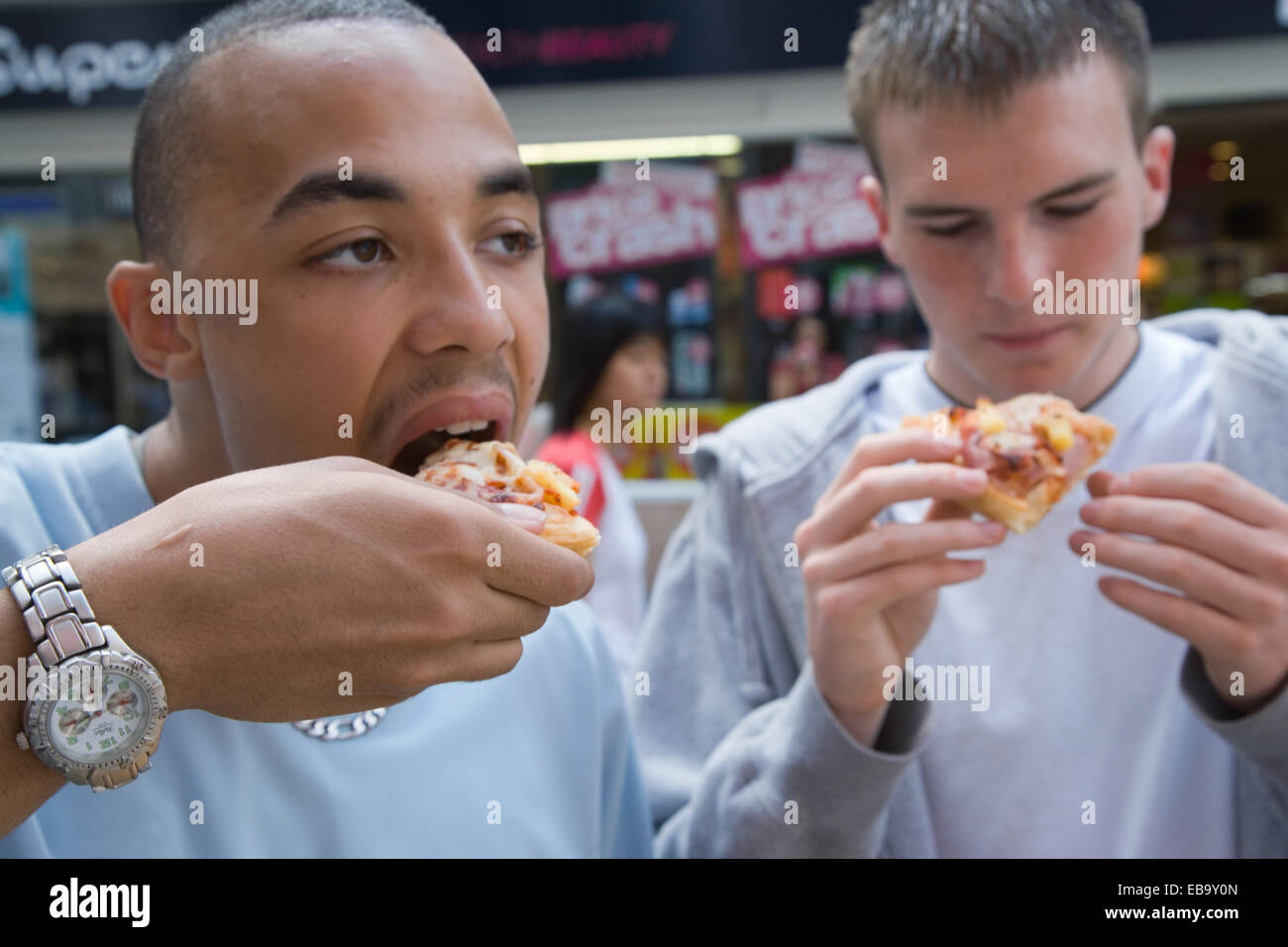 Deux adolescents snacking sur pizza, Banque D'Images