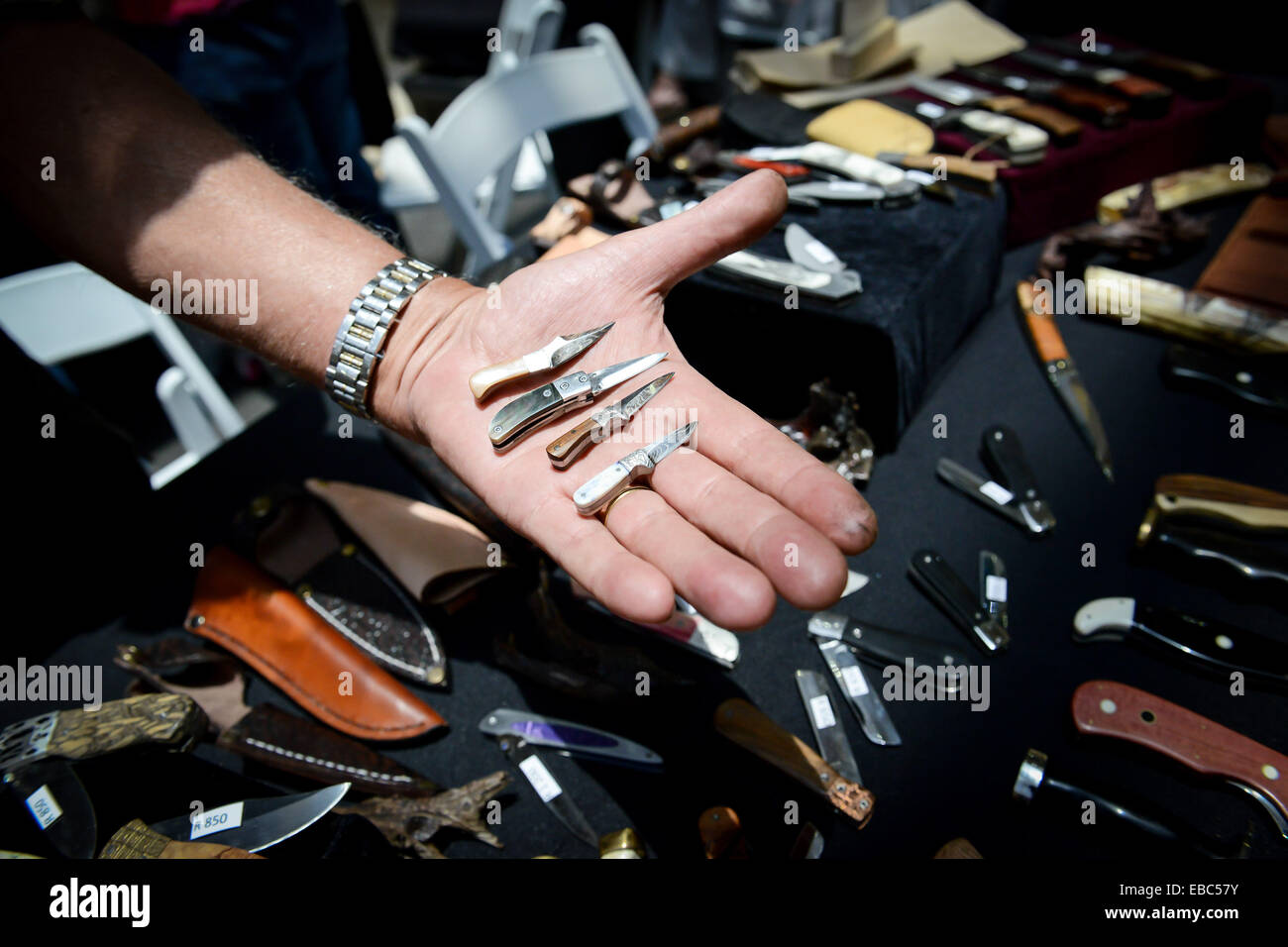 Pretoria, Afrique du Sud. 28 Nov, 2014. Un couteau bouilloire montre ses petits couteaux, l'un des plus petits qui n'est qu'à 5cm de long, au cours de la Brooklyn Knife Show à Pretoria, Afrique du Sud, le 28 novembre 2014. Le couteau de Brooklyn, qui est la plus grande exposition des couteaux fabriqués à la main en Afrique du Sud, le coup d'ici vendredi. Un total de 32 exposants y montrer sur 1 000 couteaux unique ils ont fait en trois jours. © Zhai Jianlan/Xinhua/Alamy Live News Banque D'Images
