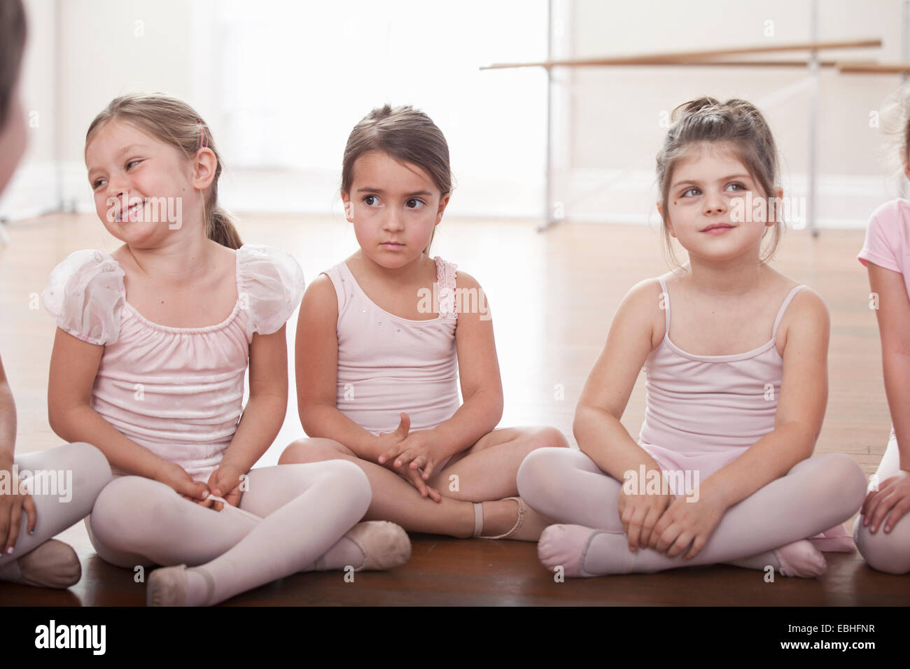 Groupe de filles assis sur le plancher en ballet school Banque D'Images