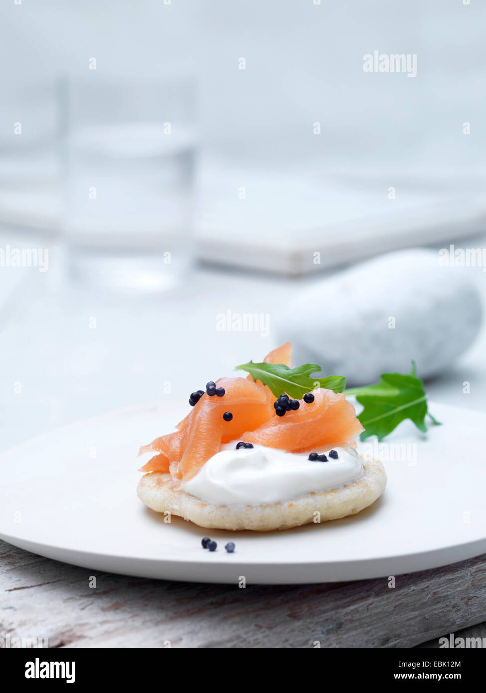 Fromage à la crème et saumon fumé sur blinis au caviar de biscuits gaufrette et feuilles de roquette décorer Banque D'Images