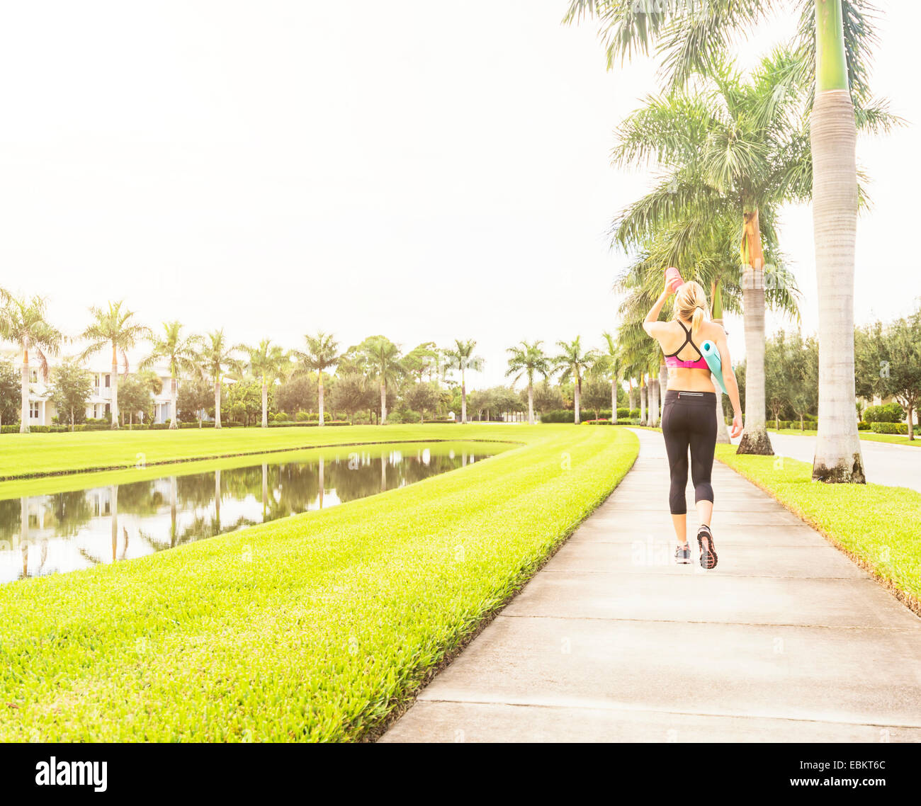 USA, Floride, Jupiter, femme à marcher le long de l'eau potable promenade Banque D'Images