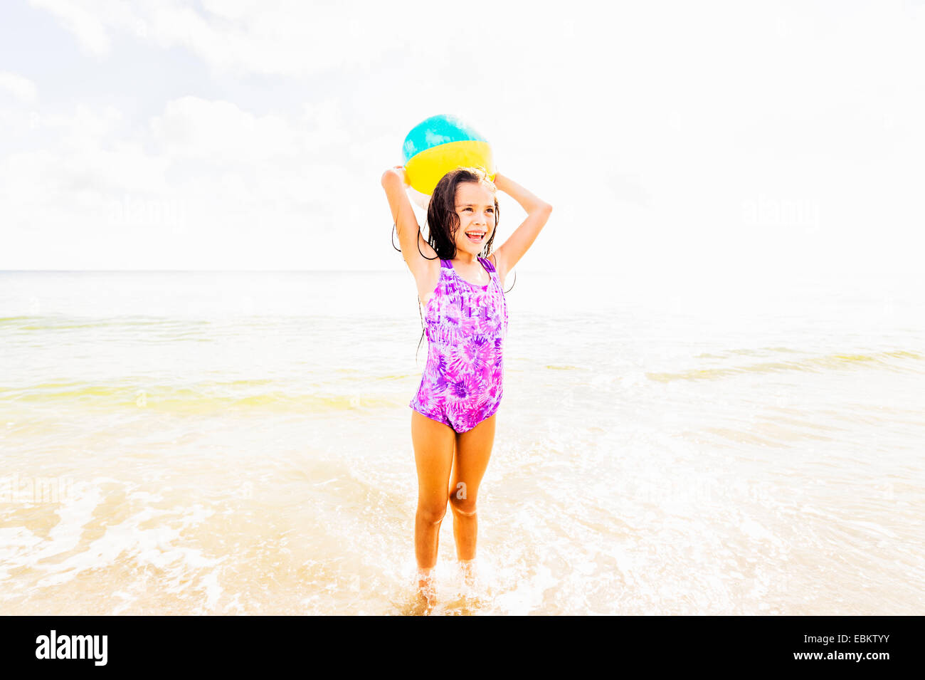 USA, Floride, Jupiter, Girl (6-7) Playing with ball on beach Banque D'Images