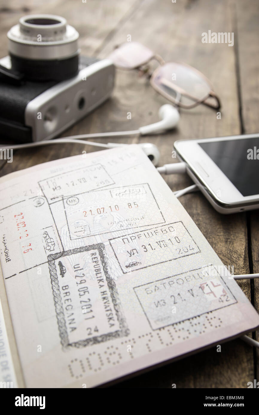 Préparation pour le voyage, d'un téléphone cellulaire, appareil photo, passeport on wooden table Banque D'Images