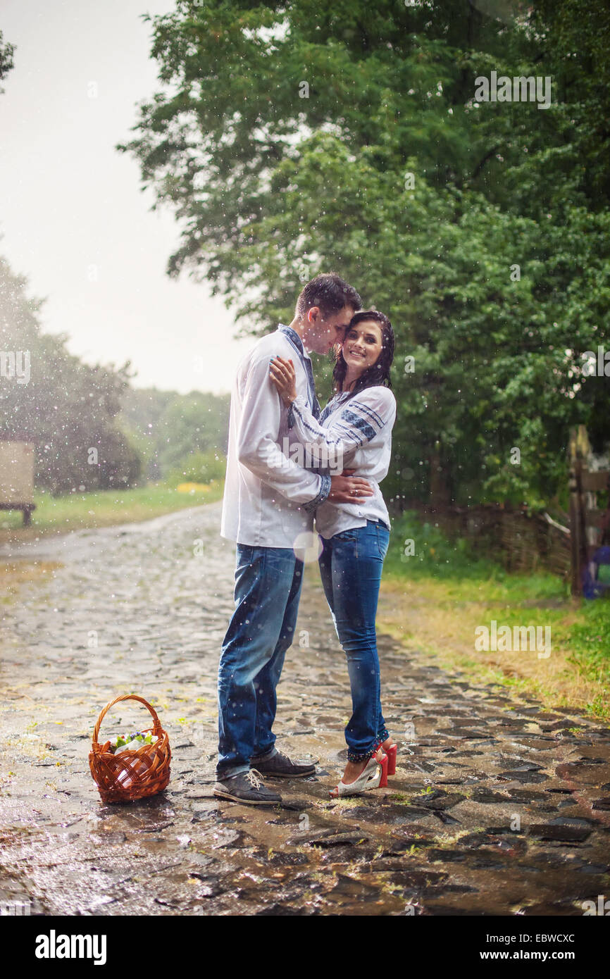 Jeune couple en ukrainien vêtements de style debout sous la pluie Banque D'Images
