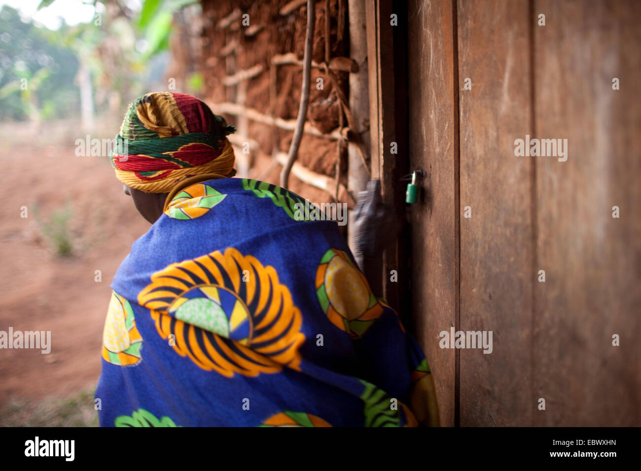 Vieille Femme de sortir de sa chambre et de fermer la porte, Burundi, Karuzi, Buhiga Banque D'Images