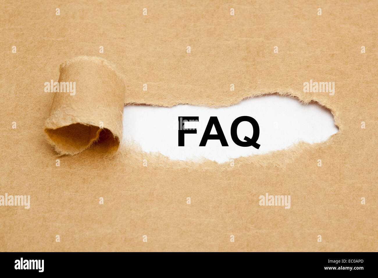 L'acronyme FAQ - Foire Aux Questions apparaissant derrière déchiré papier brun. Banque D'Images