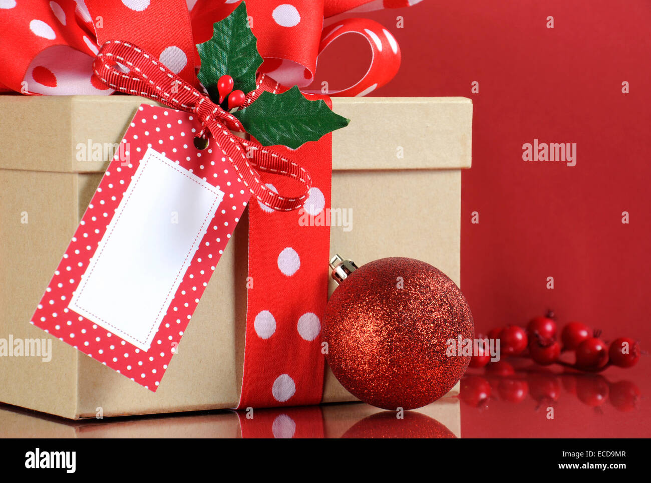 Tendance moderne naturel emballage cadeau de Noël avec boîte cadeau kraft  brun et rouge et blanc ruban à pois avec Holly Photo Stock - Alamy