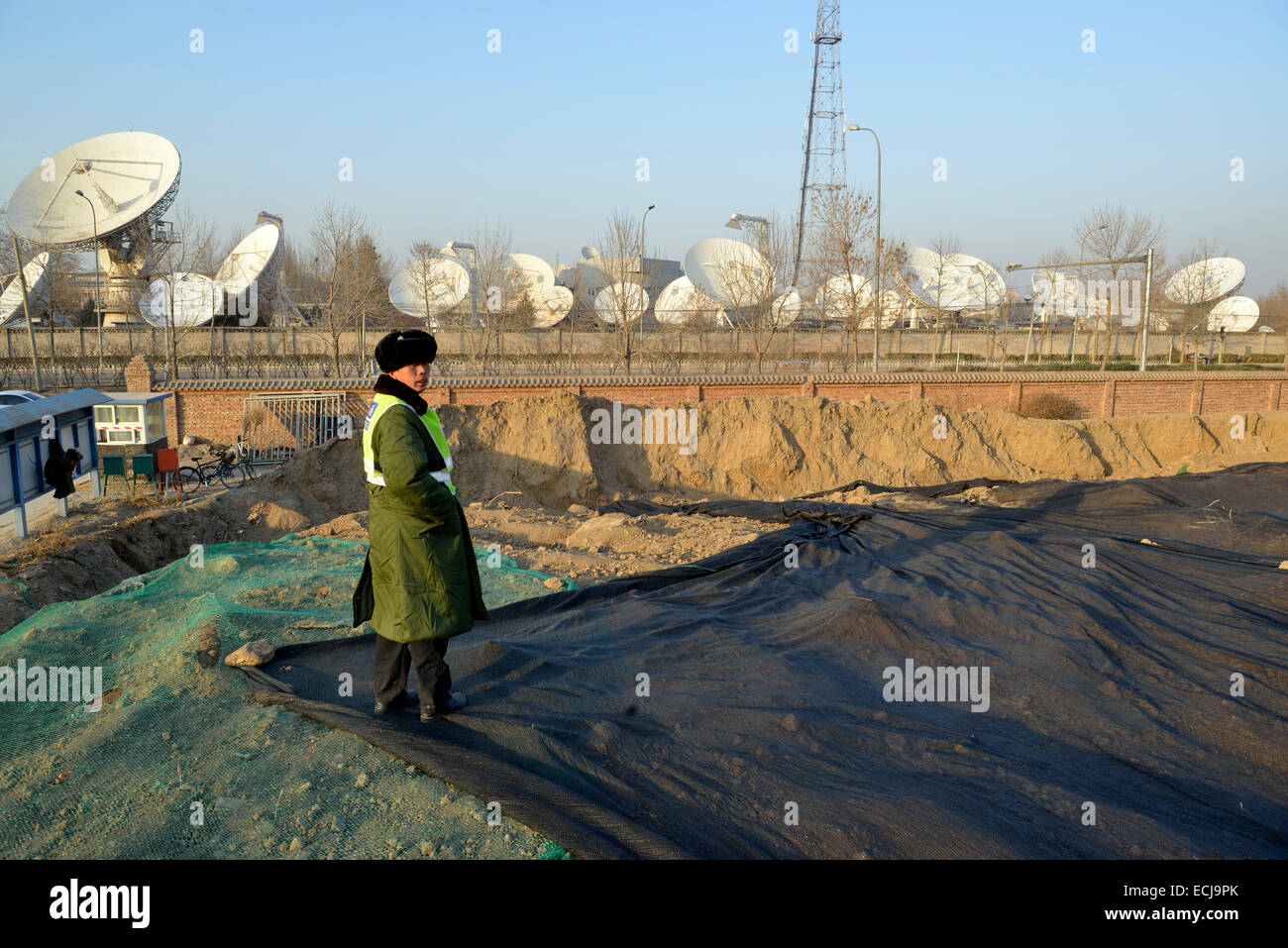 Un homme de la sécurité d'un site de construction à près de China Satellite Communications Co. Ltd, à Beijing, en Chine. 2014 Banque D'Images