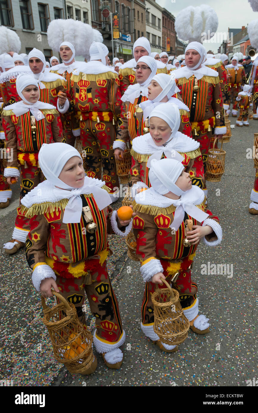 Les jeunes Gilles realiser des oranges lors d'une procession dans les rues lors de la Binche Carnaval, Binche, Belgique Banque D'Images