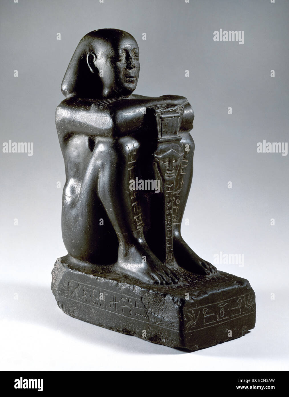 Block statue de Harsomtusemhat (664-610 B.C.) assis sur un socle, les jambes groupées et les mains sur ses genoux. Il est maintenant le sistre sesheshet, avec le visage de la déesse Hathor. Basalte. 26e dynastie. La Basse Égypte. Musée archéologique. Madrid. L'Espagne. Banque D'Images