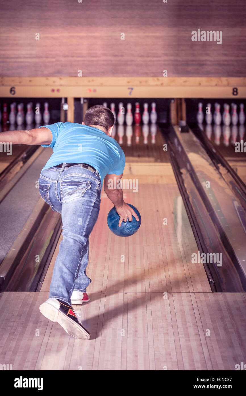 Un jeune homme jouer Bowling Banque D'Images