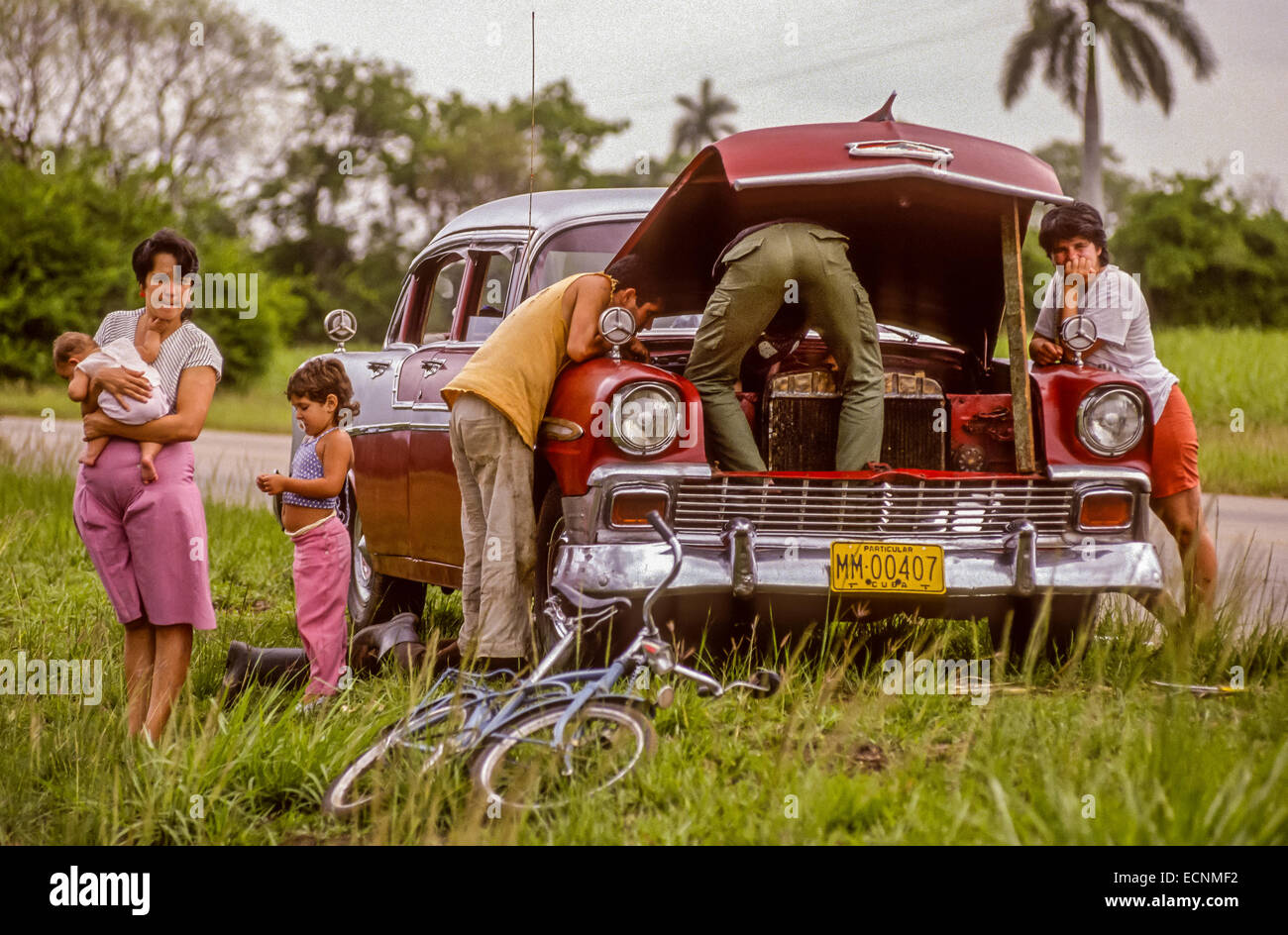 Playa Larga, Cuba 20 Avril, 1991. Famille cubaine attend pendant la réparation de voiture Chevy ventilées sur la route en milieu rural. Crédit : Rob Crandall/Alamy Live News Banque D'Images