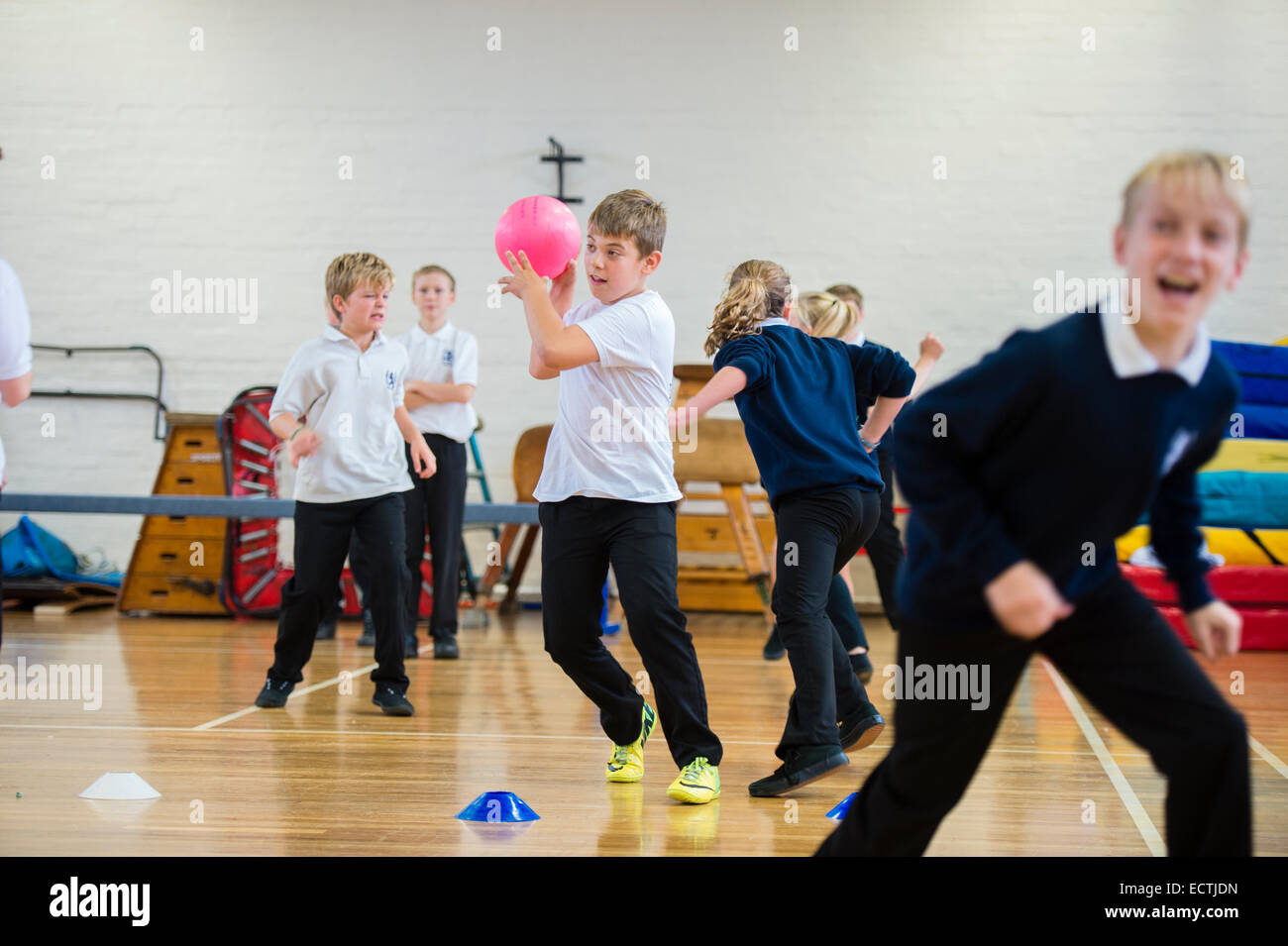 L'éducation physique de l'école secondaire de Galles UK : An 9 enfants  jouant un jeu de ballon prisonnier dans le gymnase de l'école à l'heure du  déjeuner Photo Stock - Alamy
