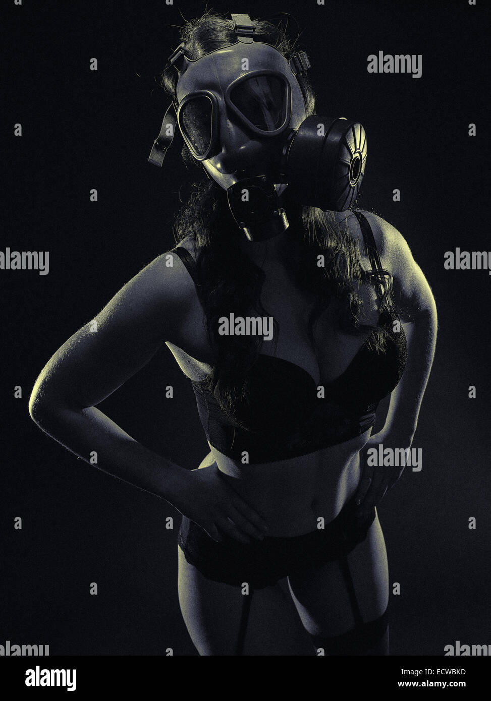Atmosphère sombre, sexy femme portant un masque à gaz et de la lingerie - split toning, image en noir et blanc, grain de film intentionnelle adde Banque D'Images