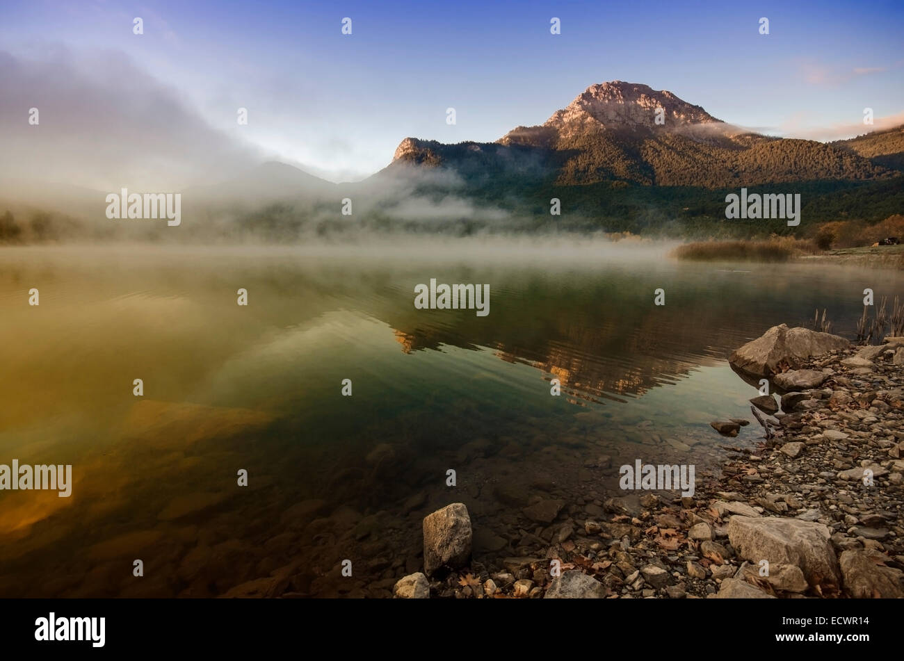 Lever du soleil avec la brume au-dessus d'un lac Banque D'Images