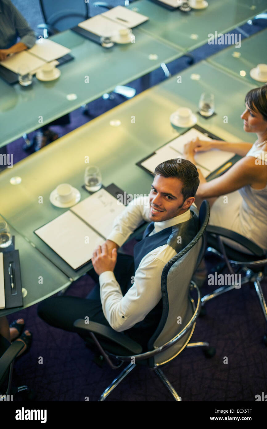 High angle view of young businessman sitting at conference table Banque D'Images
