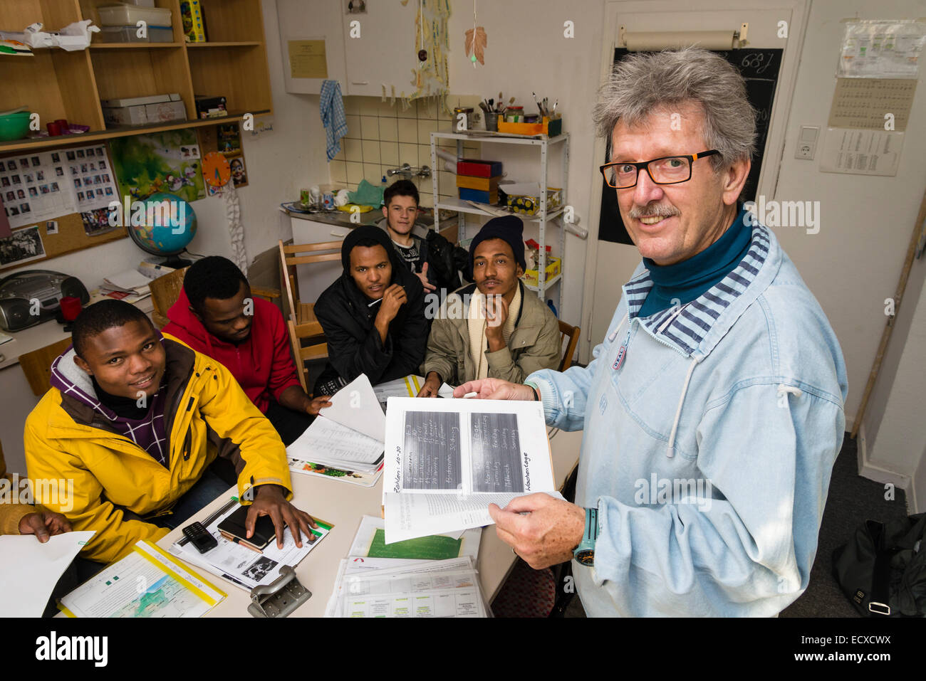 Un ancien travailleur social, le bénévolat maintenant (à droite), donne une leçon en langue allemande pour la plupart de réfugiés africains. Banque D'Images