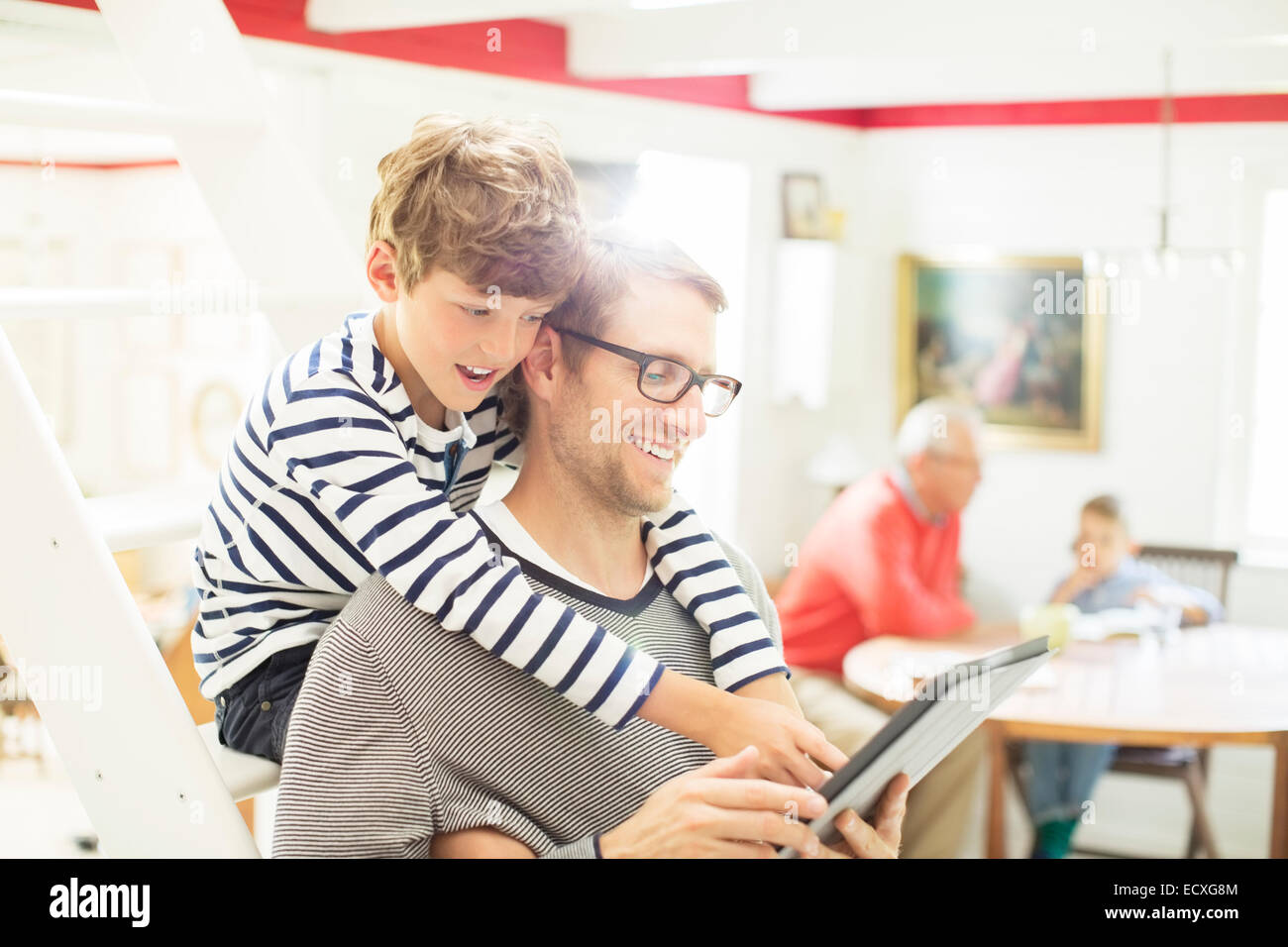 Père et fils using digital tablet Banque D'Images